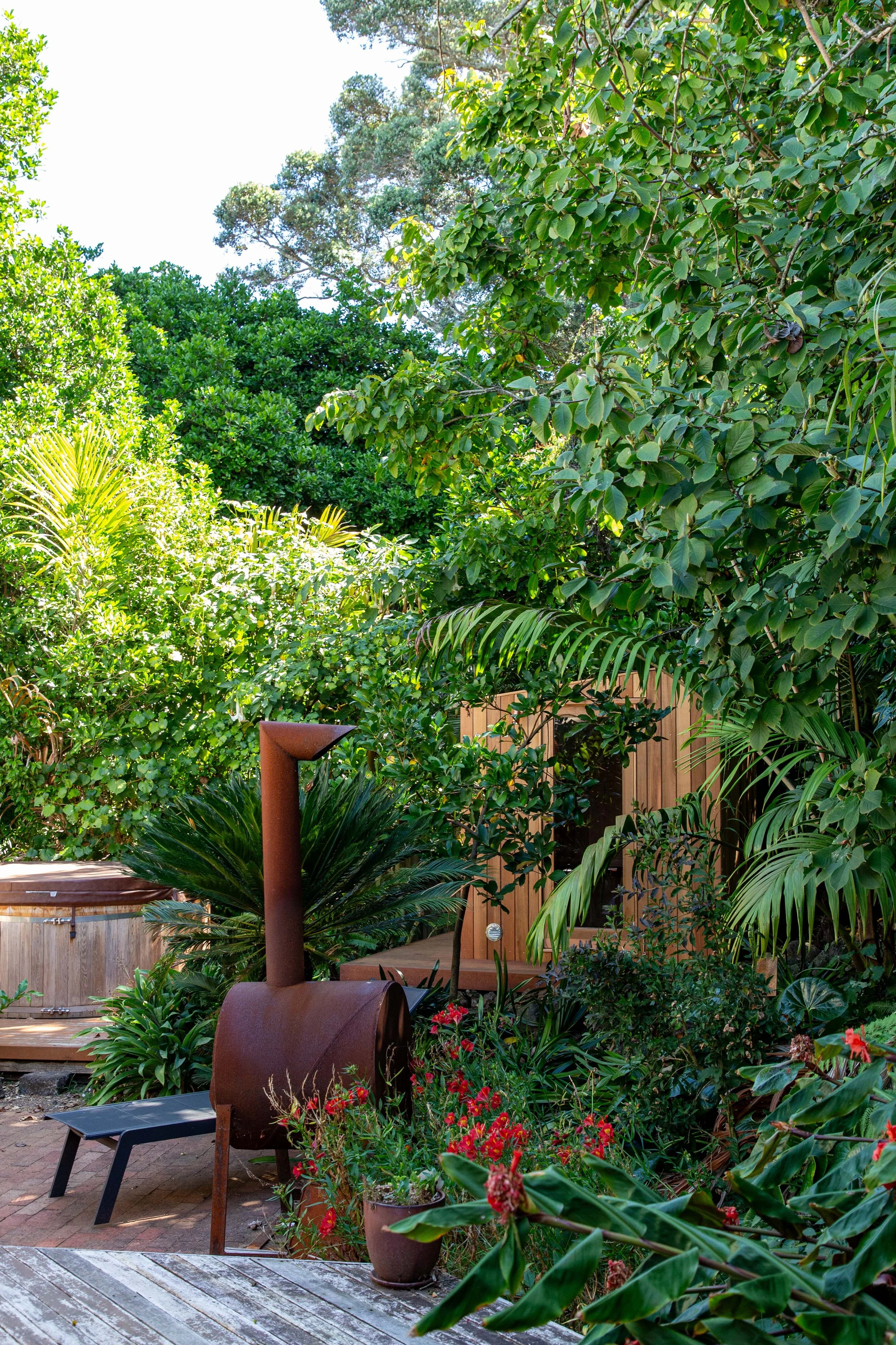 Outdoor Cedar sauna elevating an established garden in Auckland