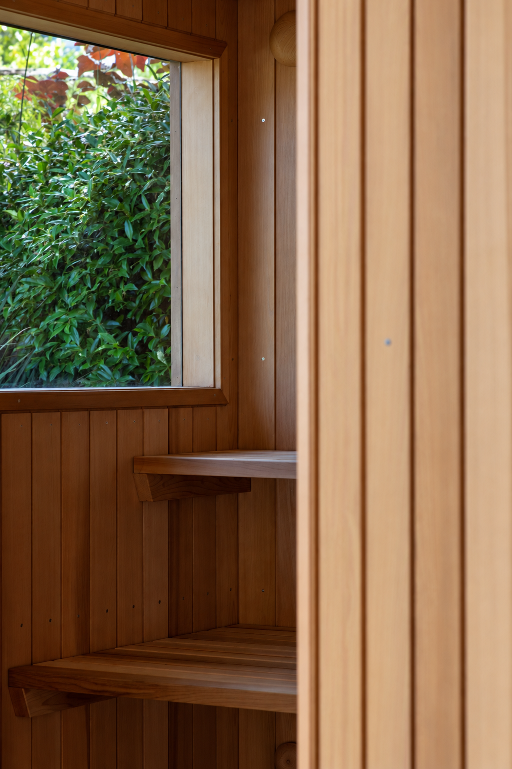 Warm Cedar Sauna Interior with Garden View.png