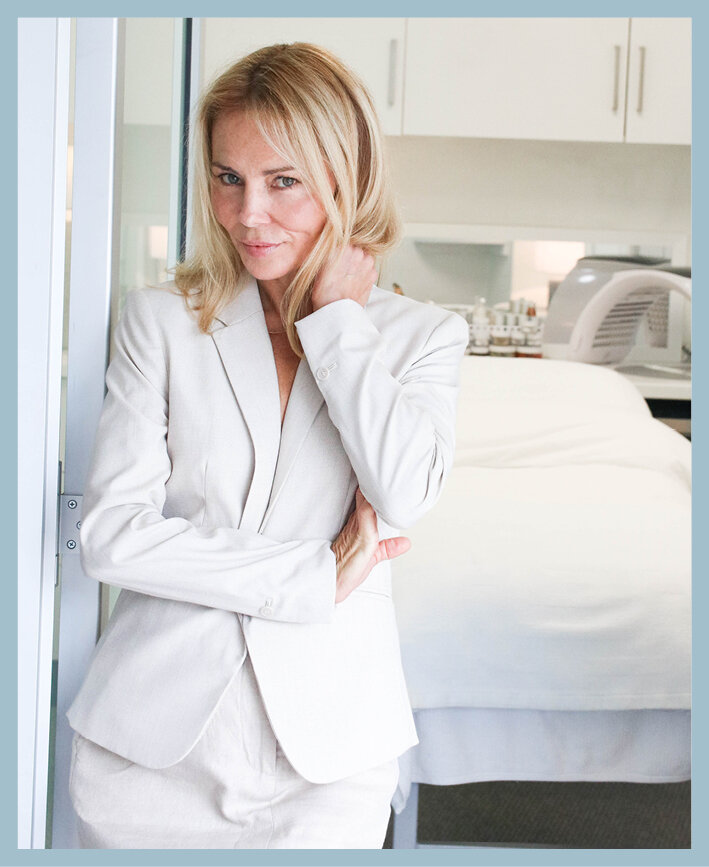 Ingrid Seaburn wearing a white jacket and pants inside a skincare medical clinic