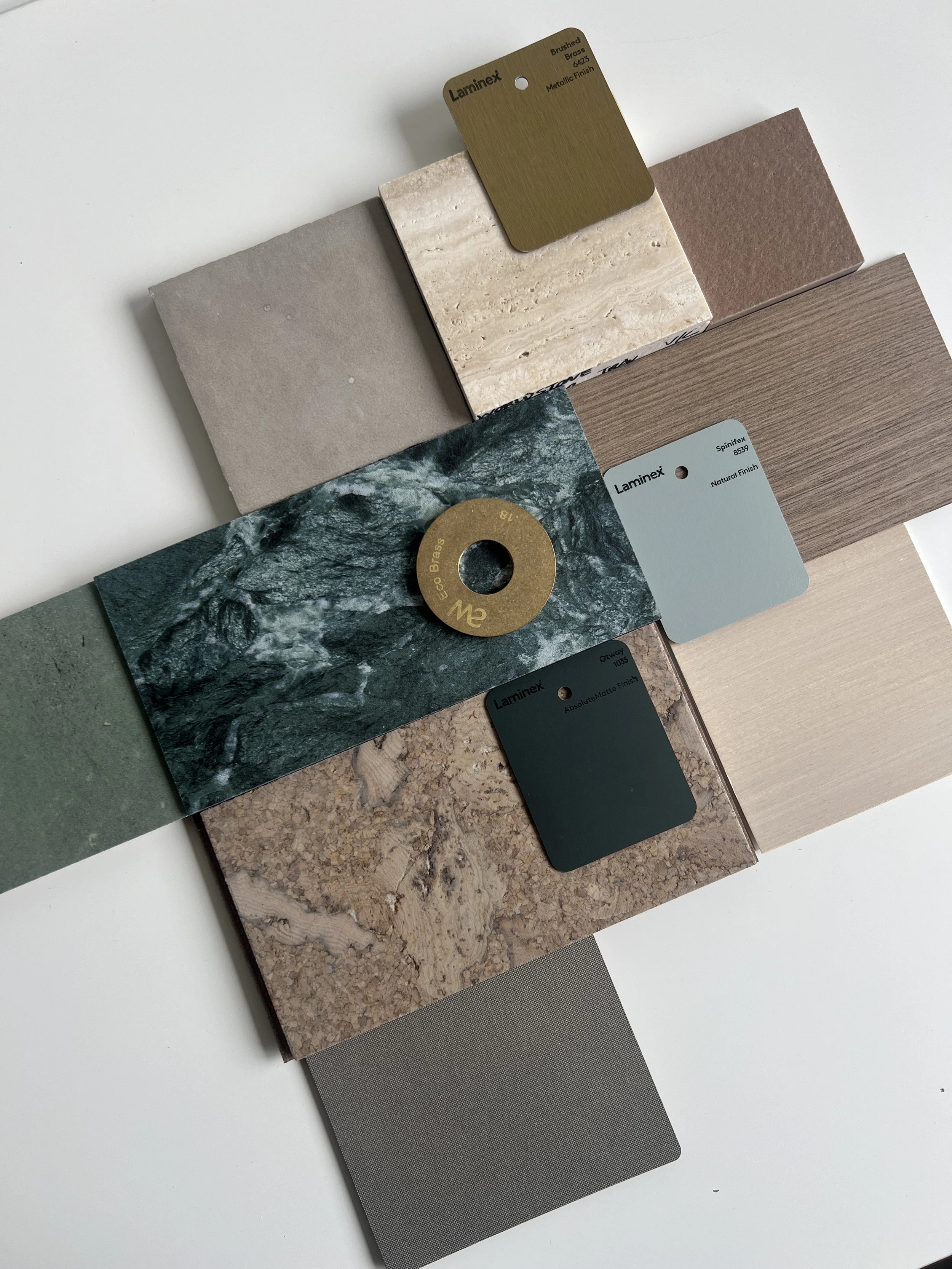 Collection of various textured and colored material samples, including stones, wood, and fabric, with color sample cards from Laminex.