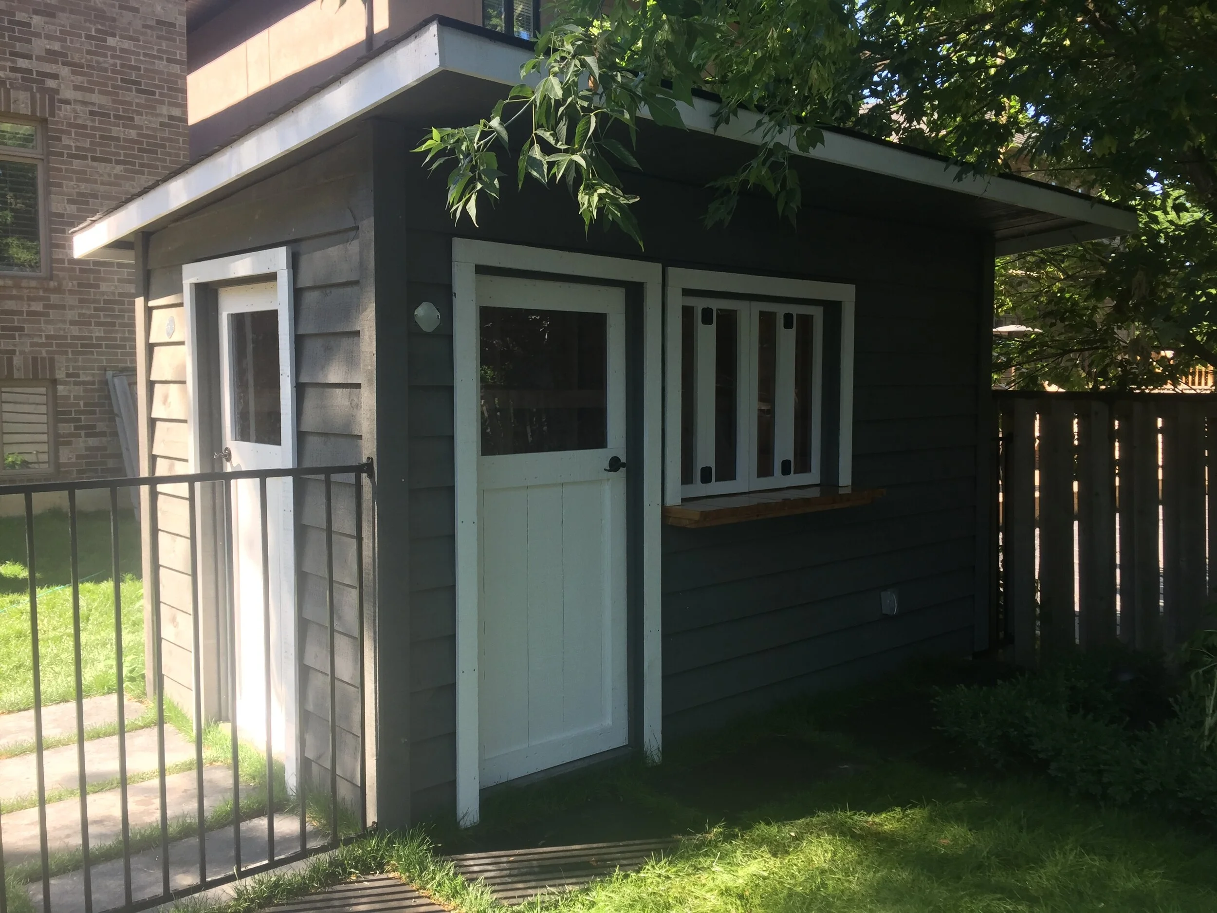 Shed:   
6x12 Lean-To (82" Eave) $4027  
 Options:   
2'x12' Overhang $739  
4' Cedar Bar with Windows $ 840 
Custom Stain $195 
2 x Custom Doors $395 
 Total: $6196