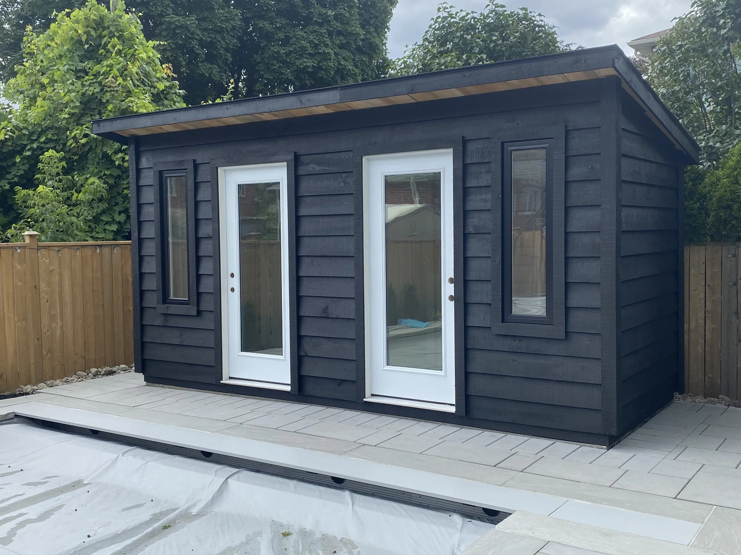 Shed:   
8'x16' Lean-To (96" Eave)  $7384  
 Options:   
2 x Custom Windows $1185 
2 x Doors w/ Windows $1740 
Plywood Floor $448 
 Total: $10757