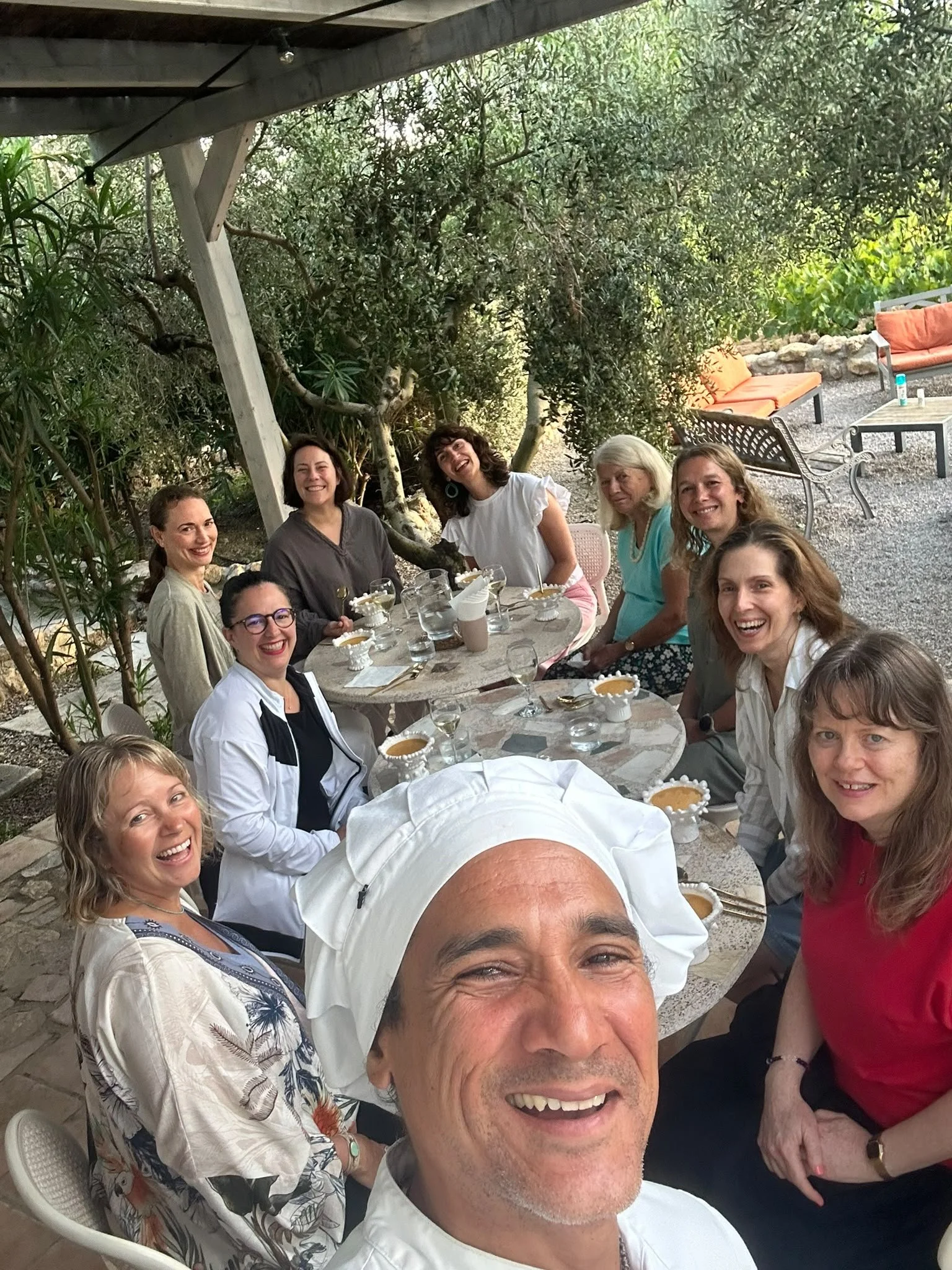 GetCalmer Retretreat guests around a dinner table outside at Soul Farm mas els igols Barcelona