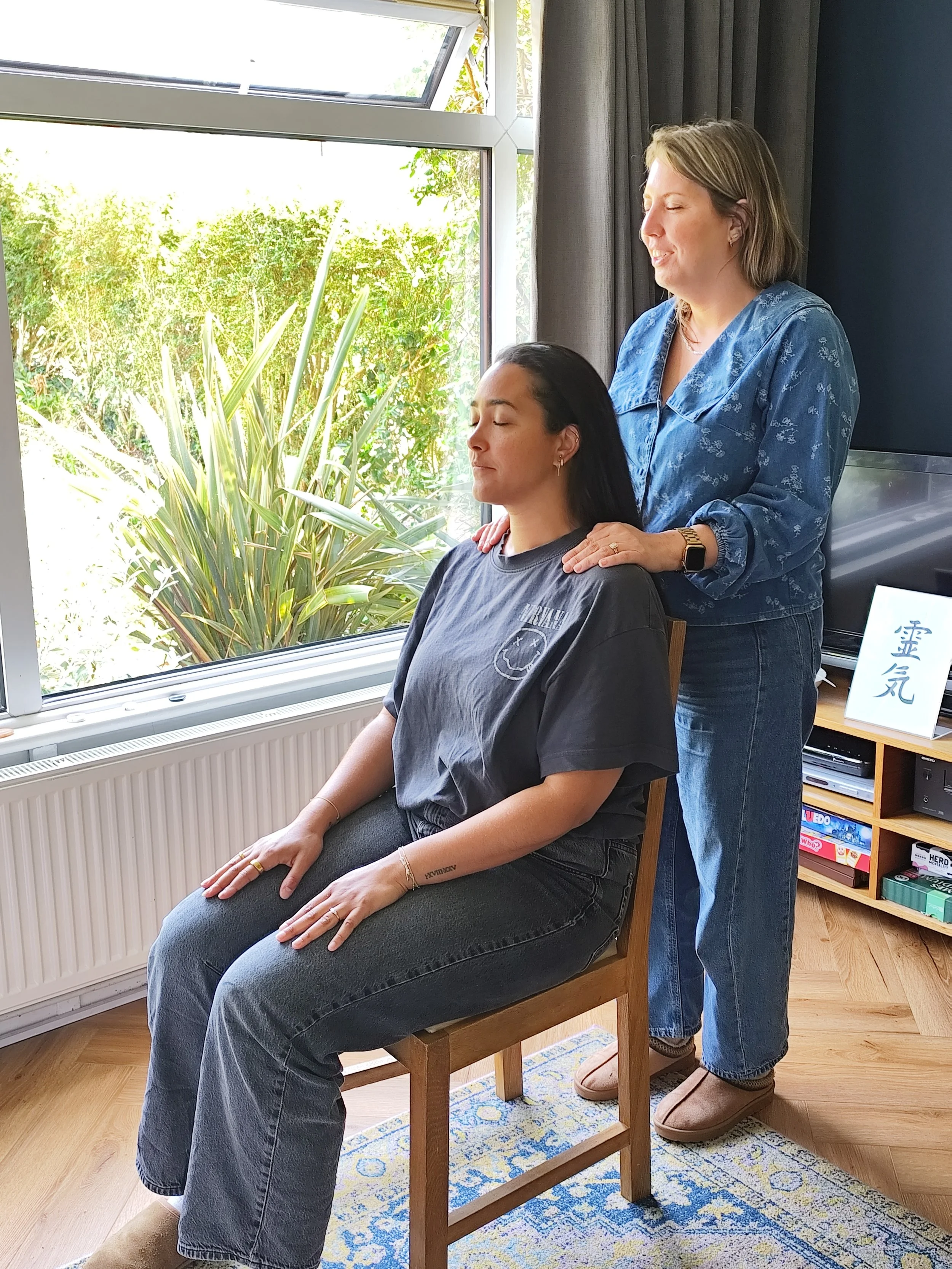 Reiki Level 1 student practising a hands-on healing treatment during training in Oxfordshire.