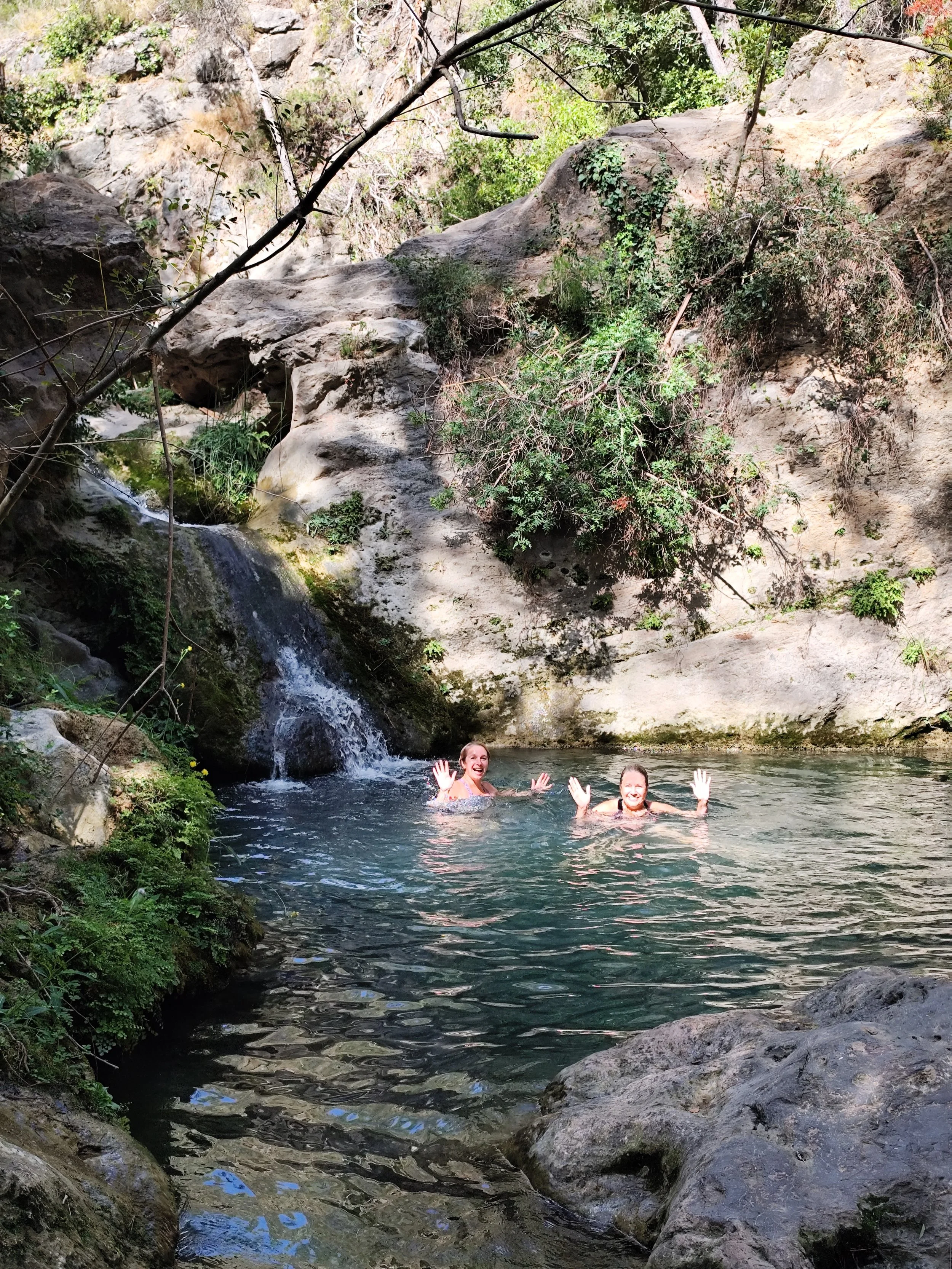 Women swimming in a natural pool together on GetCalmer yoga retreat in Spain
