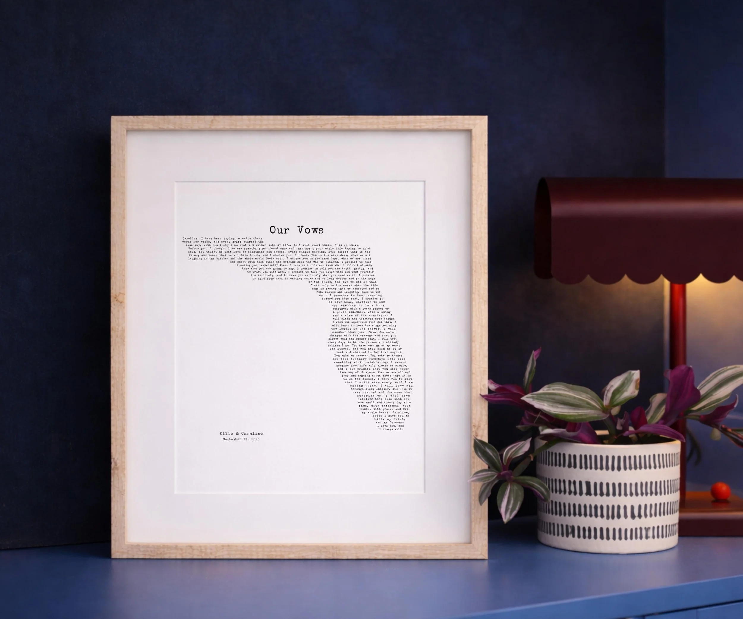 Florida wedding vows print in a light wood frame against a navy blue wall