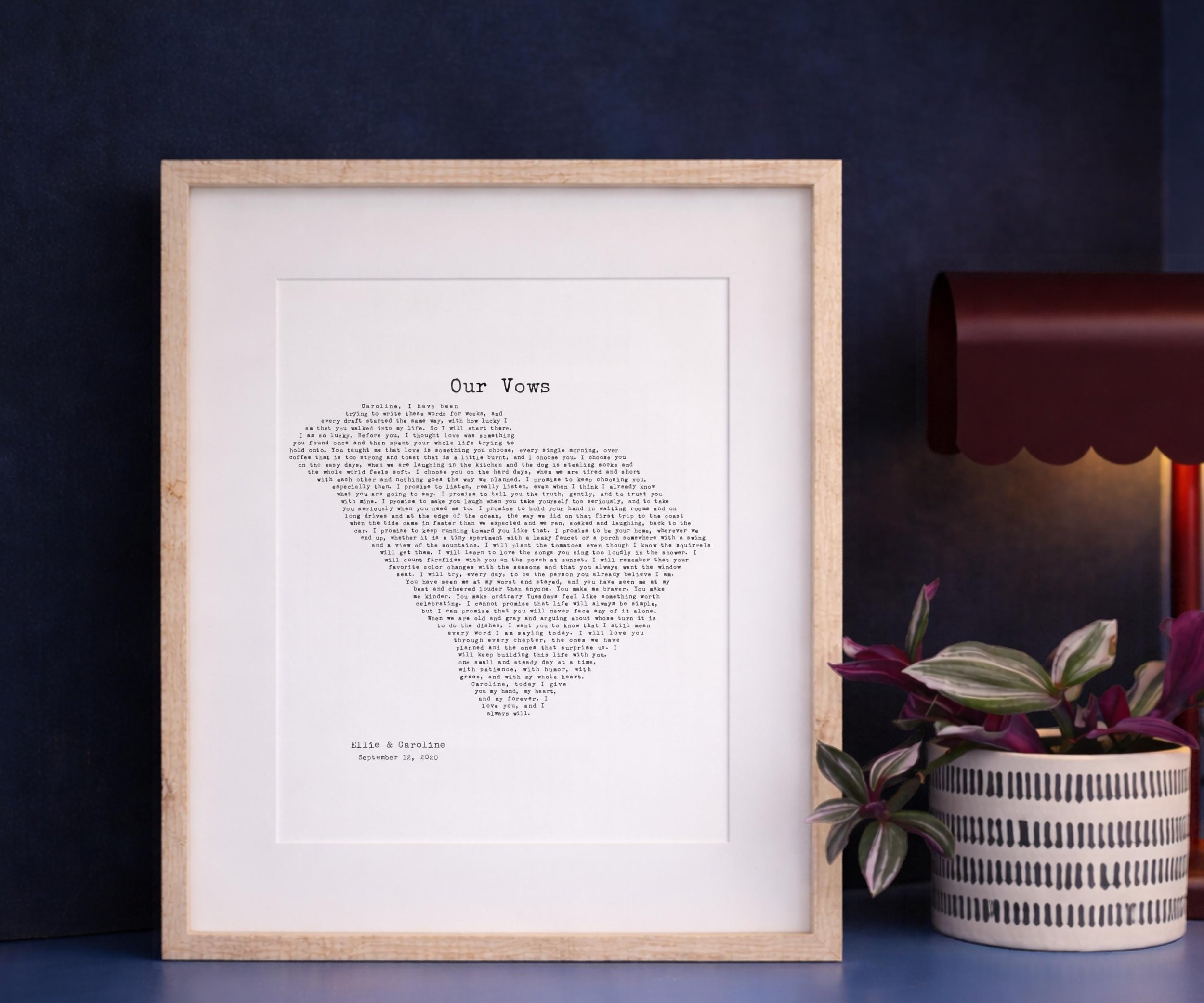 South Carolina state outline vows print in a light wood frame with white mat, navy wall