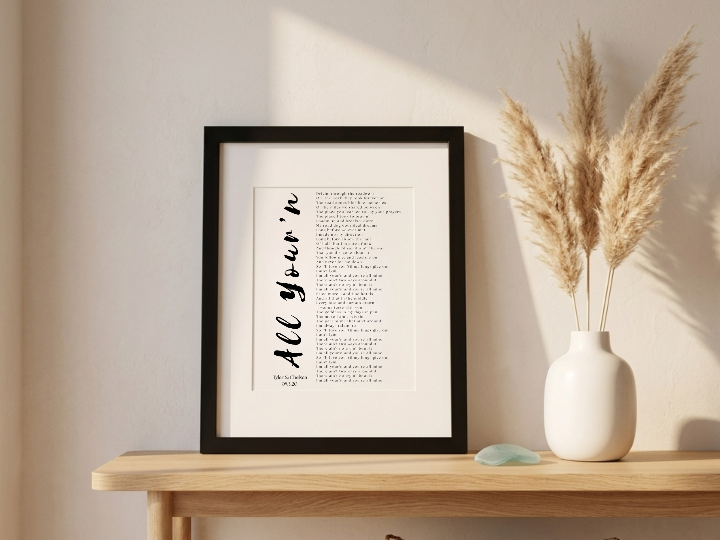 11x14 framed first dance lyrics print on cotton paper displayed on a console table with pampas grass