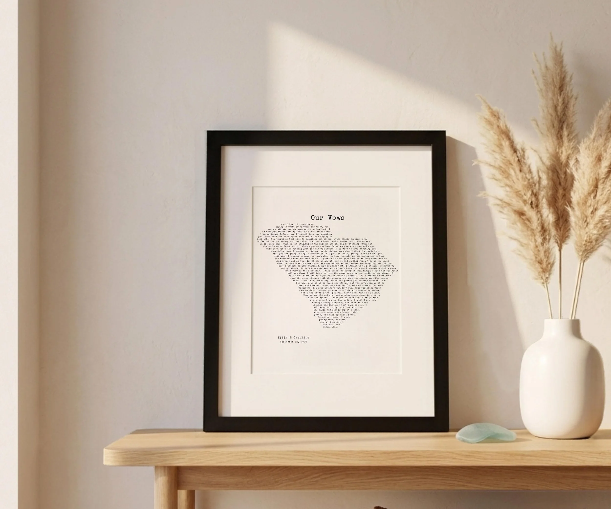South Carolina wedding vows print in a black frame on a wooden console table