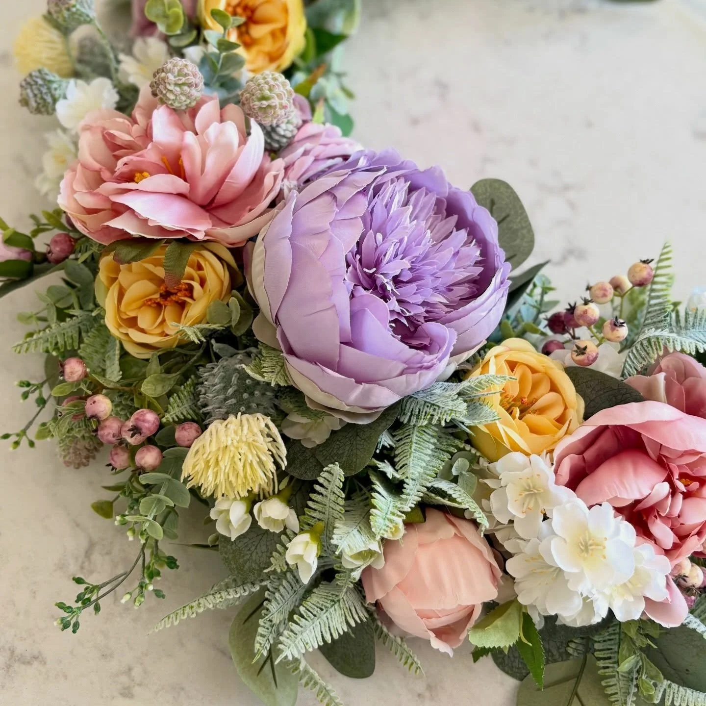 This is Claire. A soft, lush palette of peonies, roses, cherry blossoms nestled into a soft green foliage. A beautiful door wreath that transitions perfectly from spring into summer. She&rsquo;s NEW and listed - ready to be shipped to her forever hom