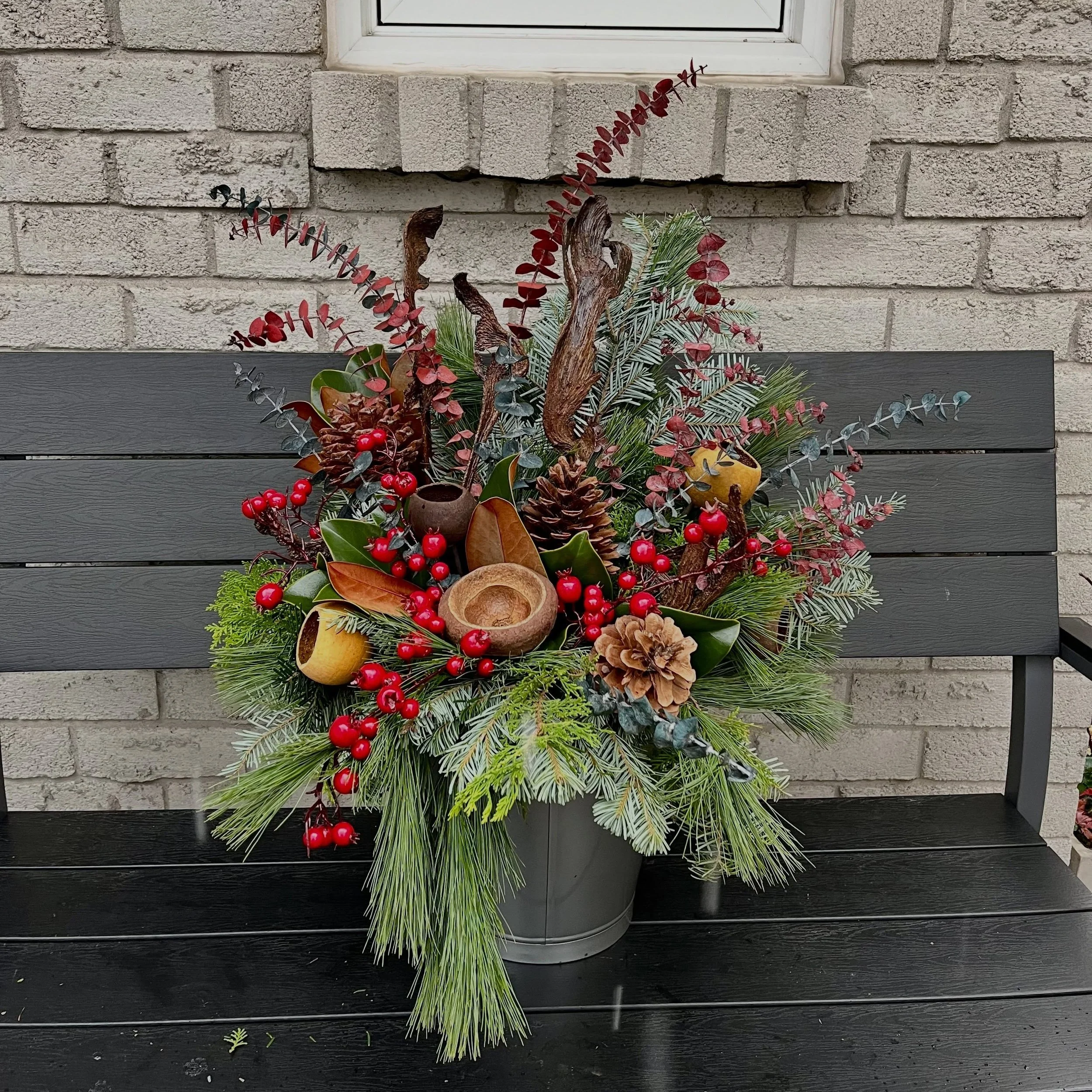 Bucket Arrangements are available each season! These are mini versions of the original classic planter designs. They come in their own metal bucket and make great hostess gifts or realtor gifts for all your customers closing ahead of the holidays!
