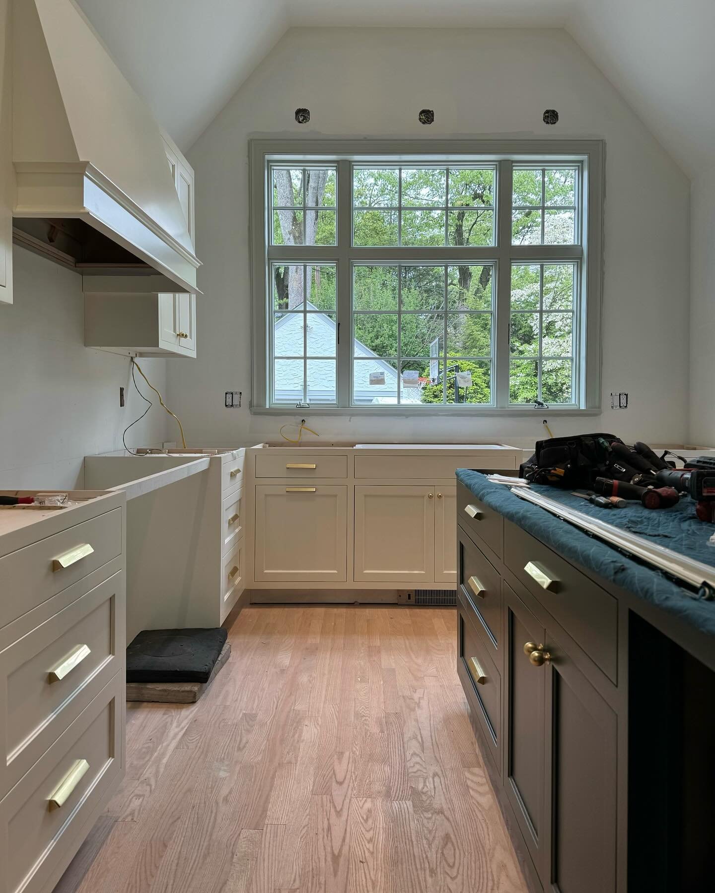 Progress on the kitchen in our Ridgewood renovation project. Swipe for where we started. A prior addition with a different roofline created two distinct and awkward areas in the kitchen. We moved the working part of the kitchen toward the back of the