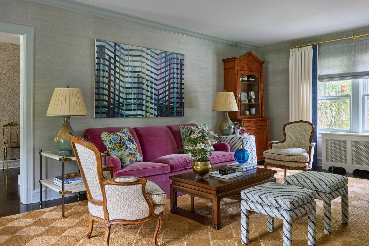 This living room already had some good pieces and the client had a great art collection. What designer would refuse that velvet sofa? Wallpaper, paint, a rug, window treatments, reupholstery and new/old casegoods brought it all together.