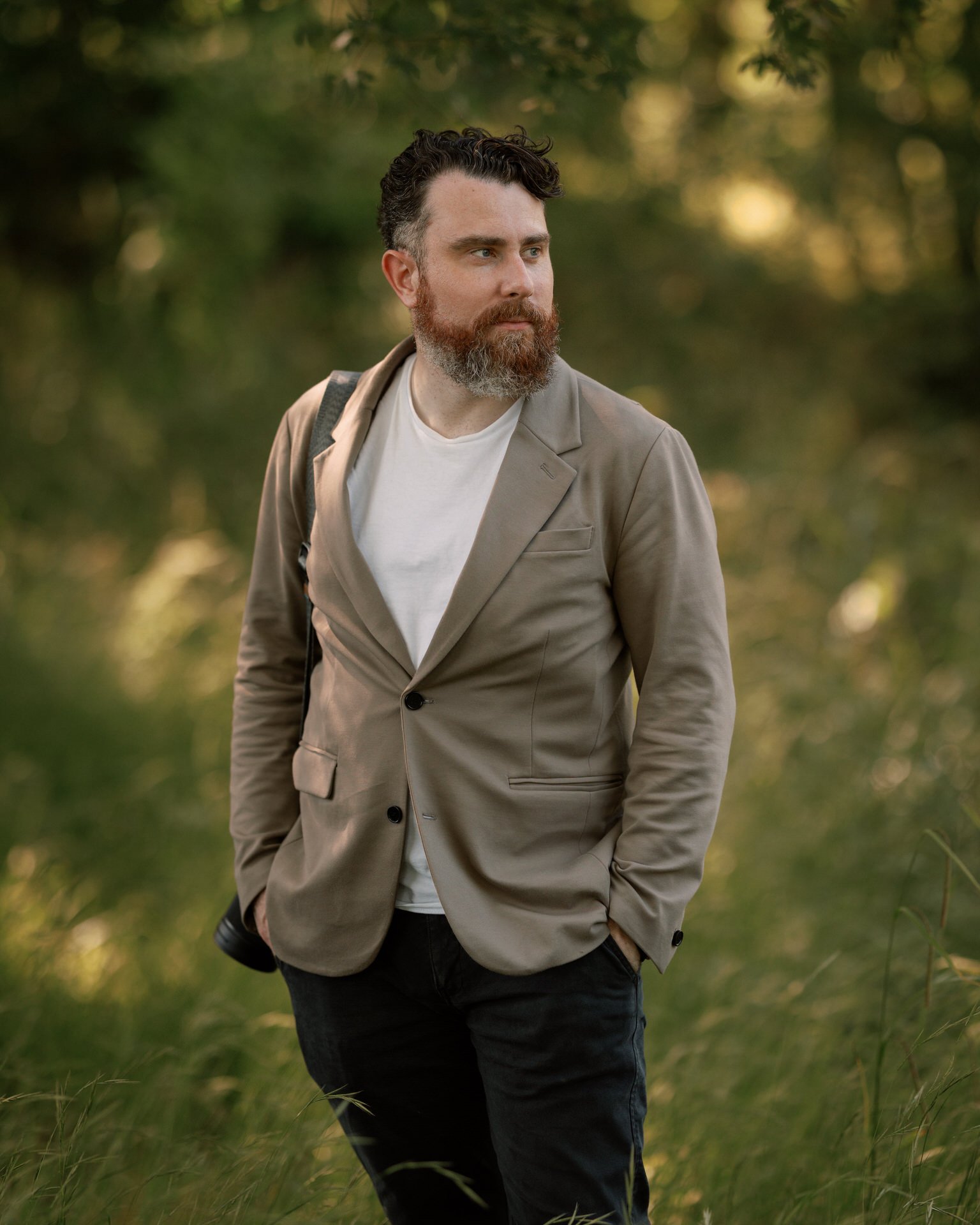 Documentary wedding photographer, Dan Higginson, camera on his sholder, working at a wedding in Kent