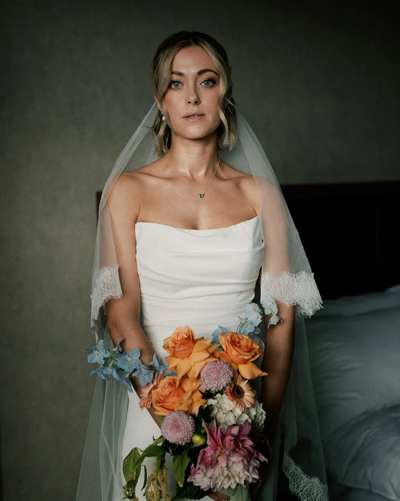 Bride in veil holding flowers before heading to the town hall for her Londonn wedding
