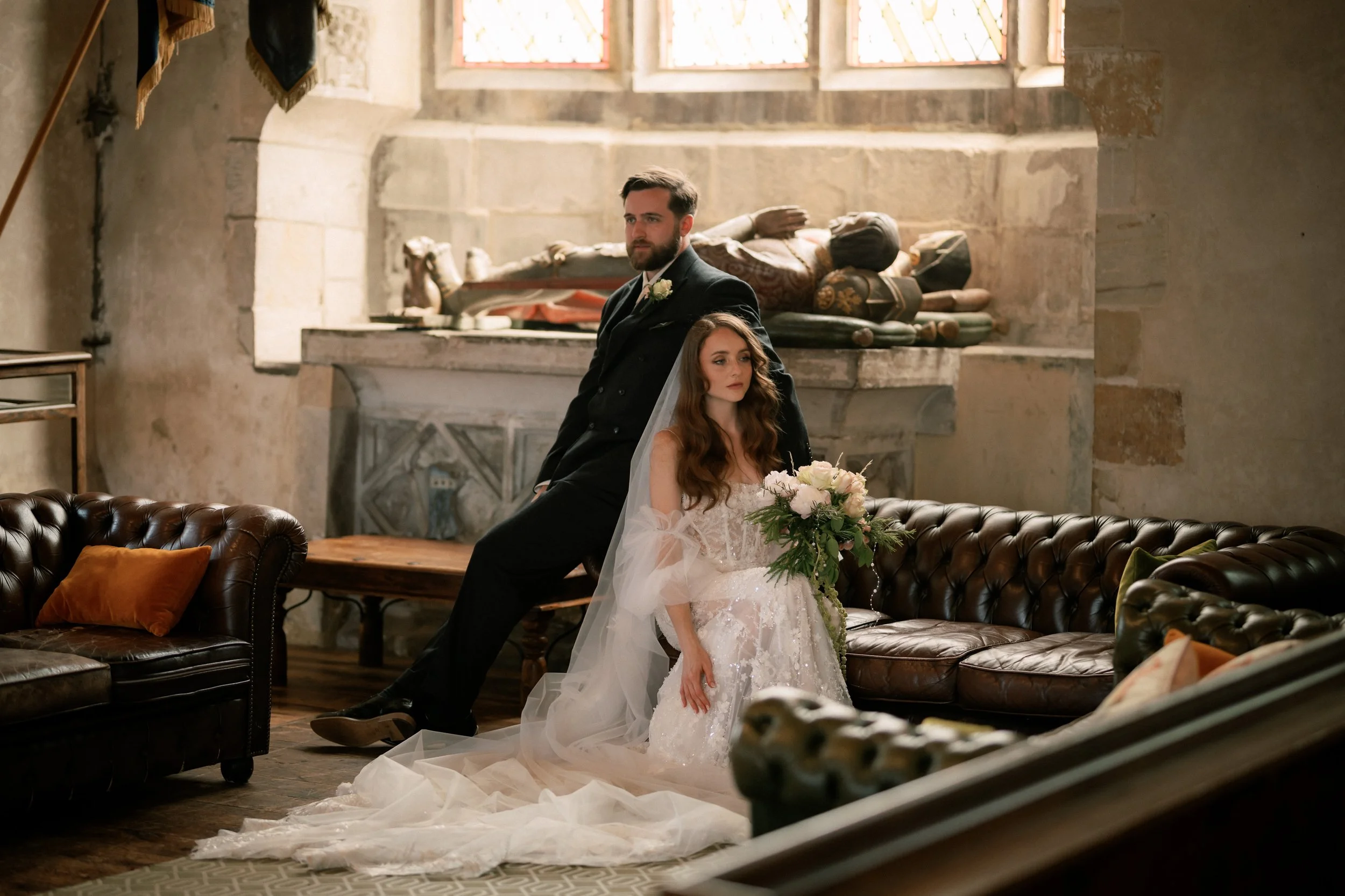 newlyweds pose for a photo in a church