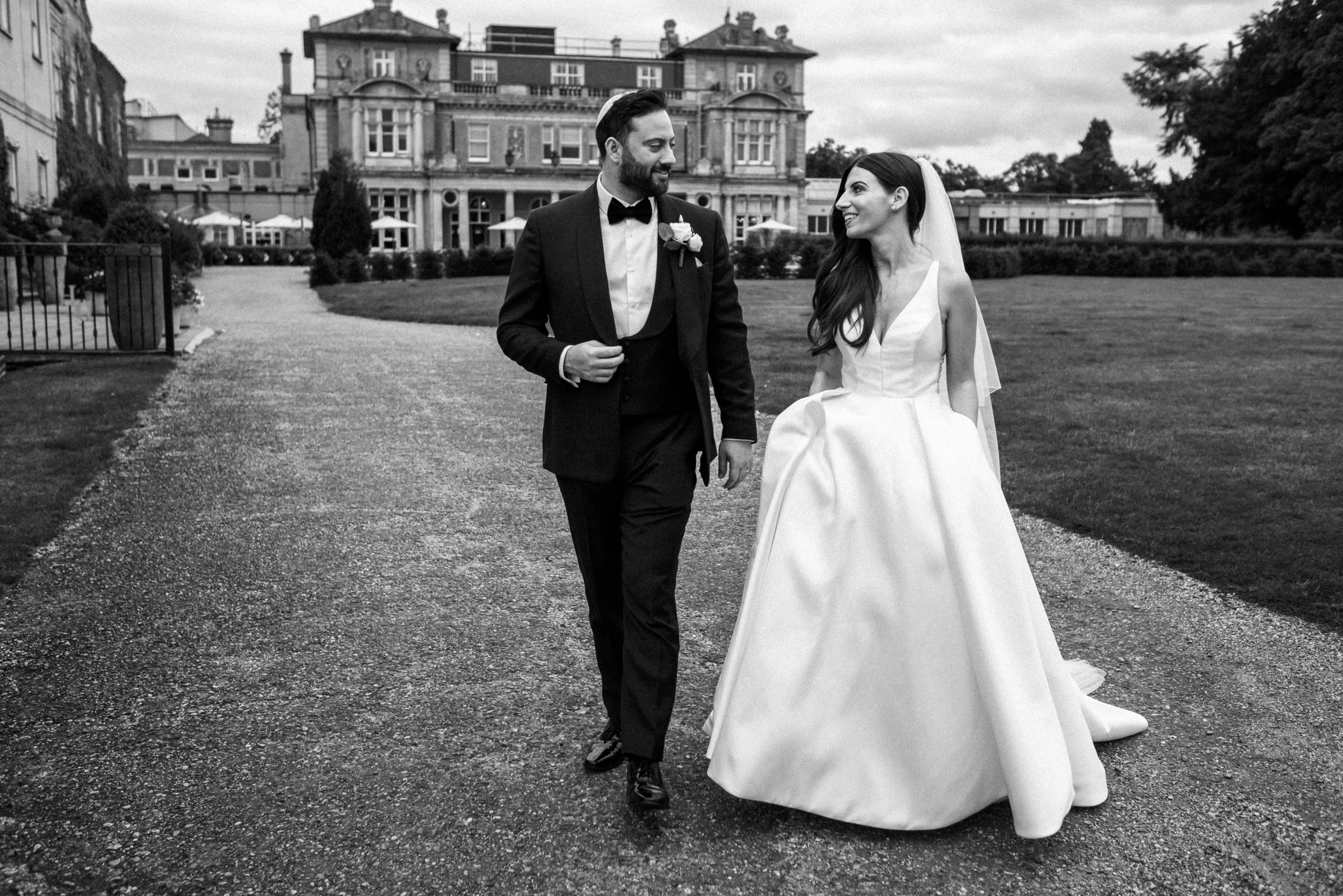 Newlyweds walking at Down Hall Hotel & Spa, Essex