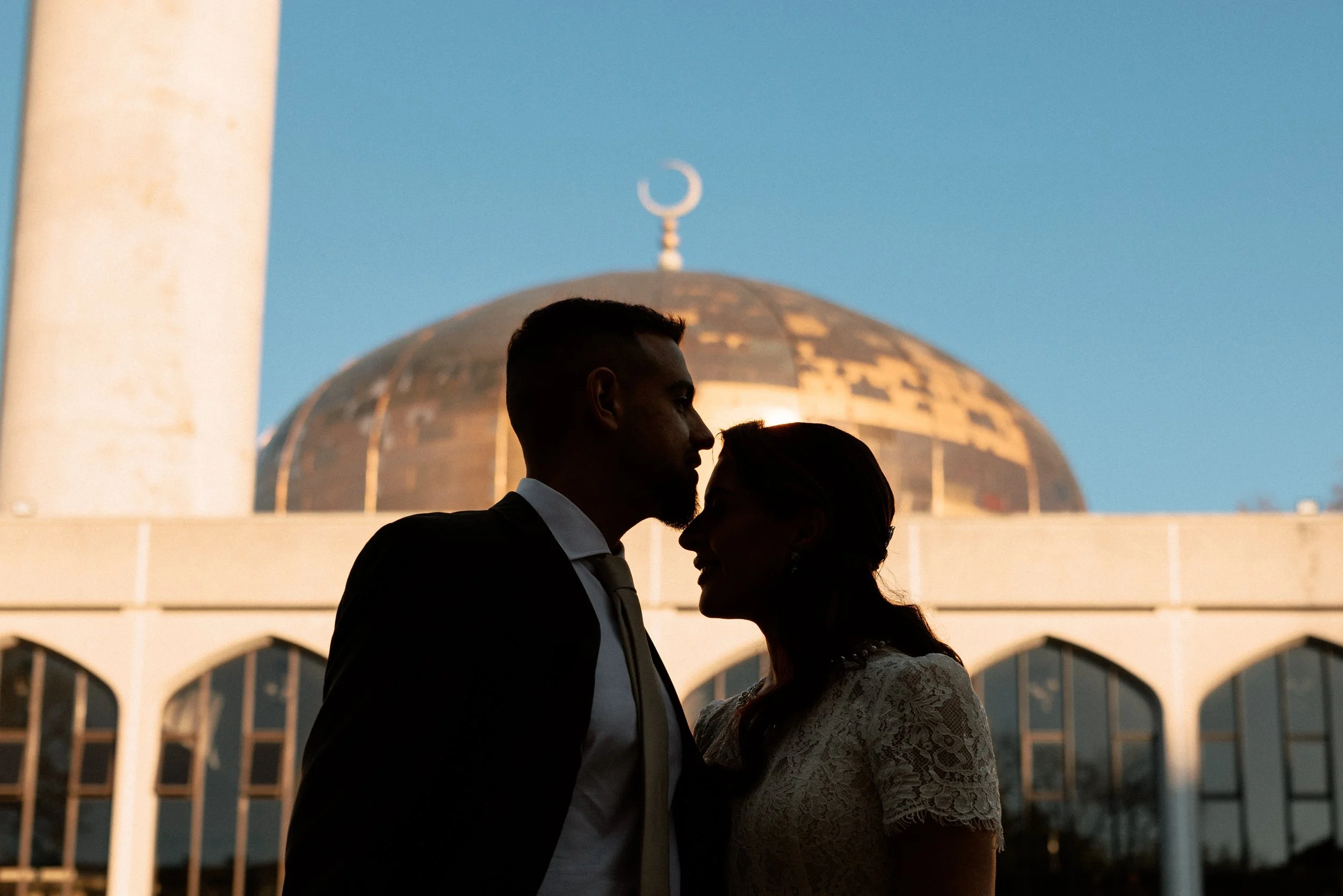 Husband and wife share a kiss in front on the day of their Islamic Nikah wedding in a Kent Mosque