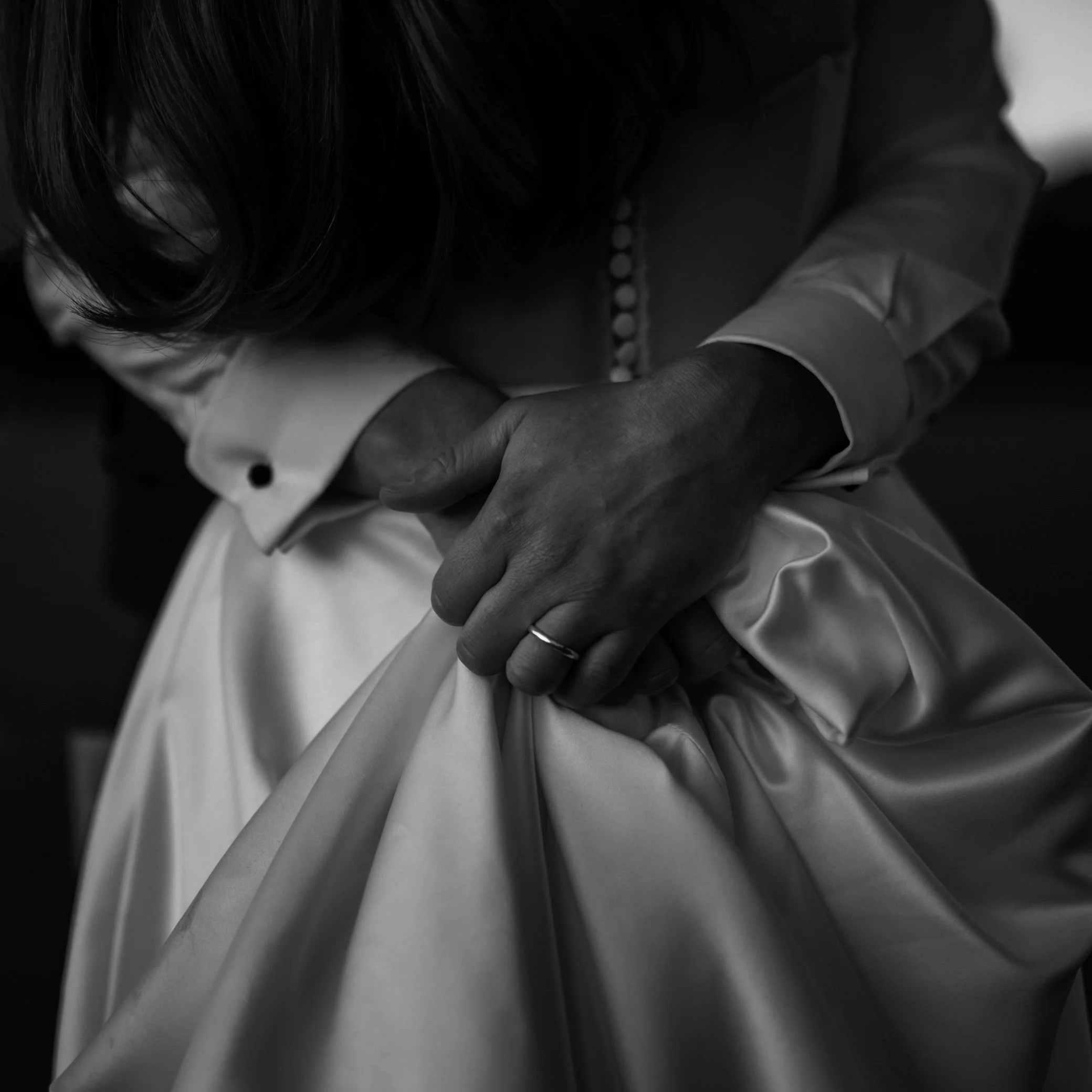 A groom embraces his wife on their wedding day in Kent.