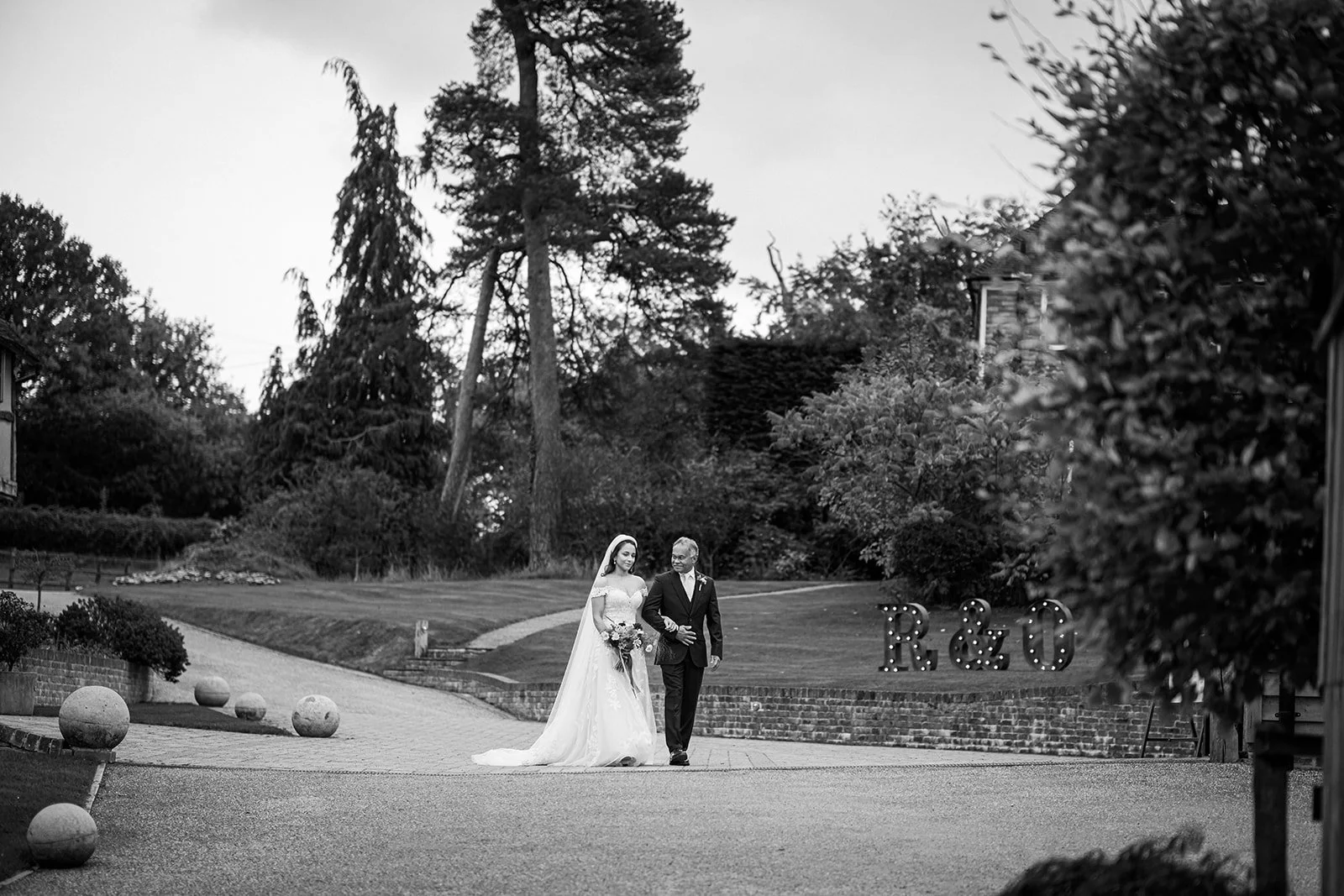 Documentary wedding photograph showing the farther of the bride walking his daughter down the aisle on her wedding day
