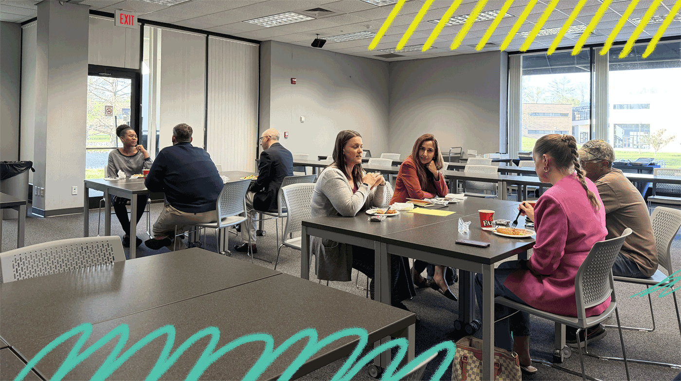 Event participants sharing lunch in a conference room.