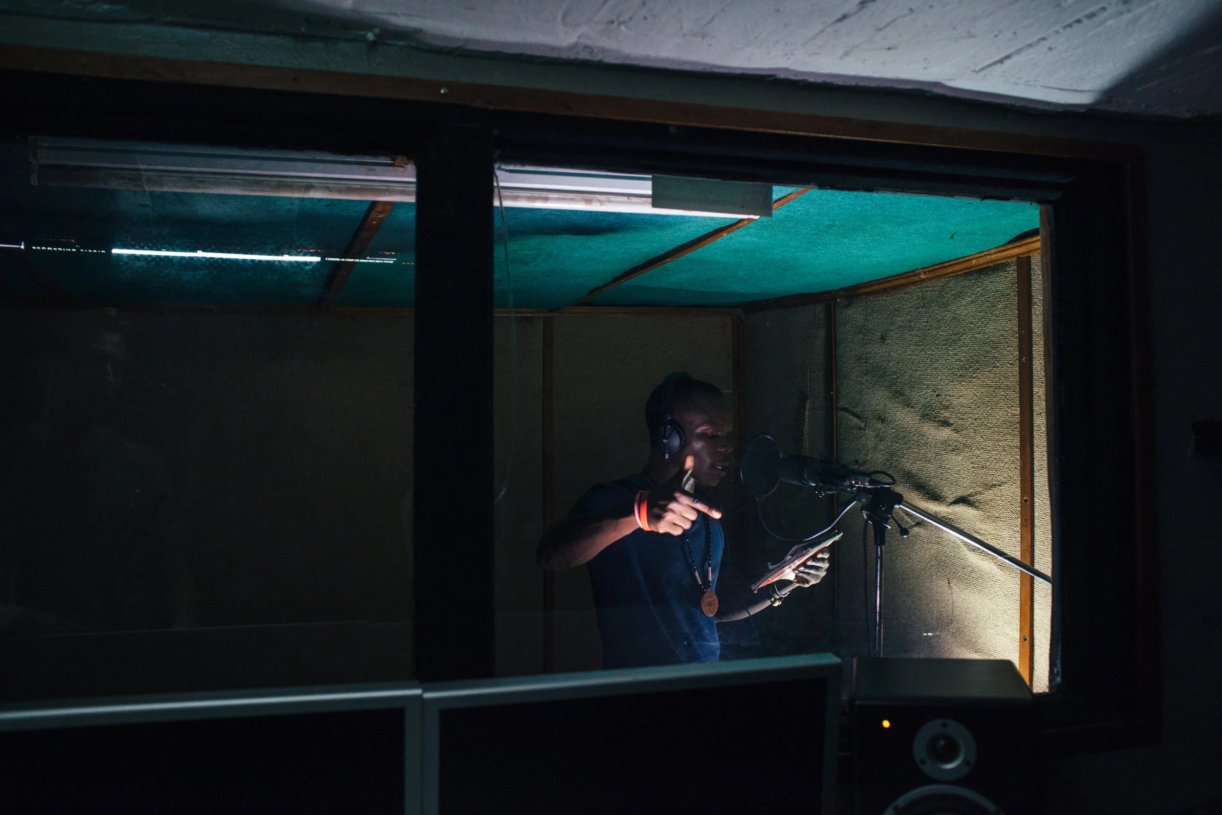 An image of a man in a recording booth.