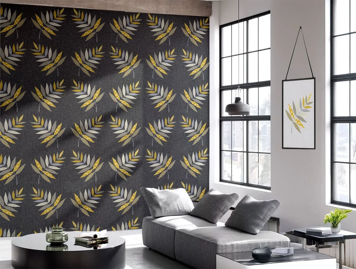 A modern lounge setting with a dark grey textured wallpaper with botanical leaves