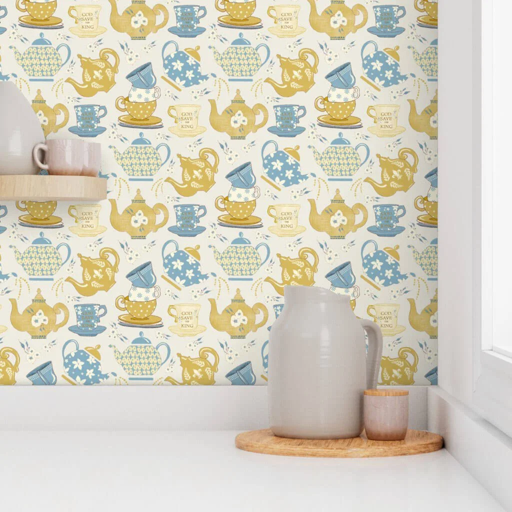 Gold and soft blue teapots on a cream background