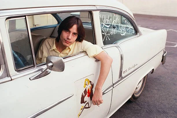 Jackson Browne poses in a car in this iconic photograph.