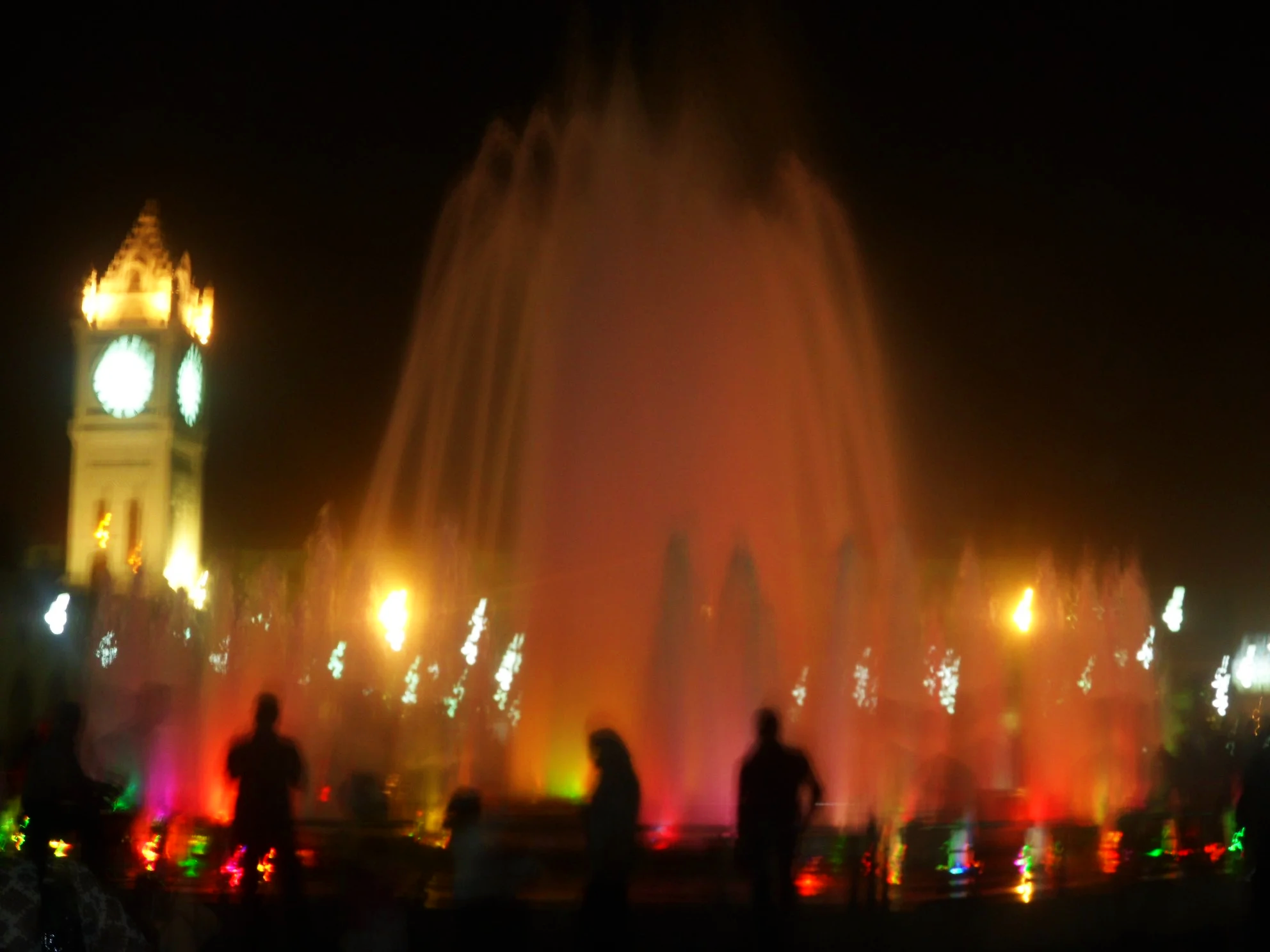 Erbil City Centre at night with fountain and clock tower.