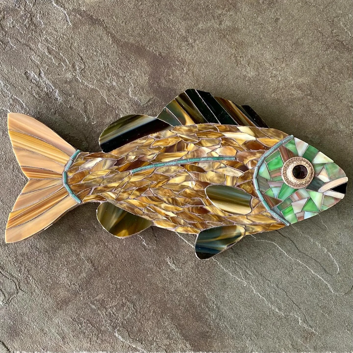 A closet clean out revealed two chain belts from the 90s, one broken and one very cool, but likely not to be worn. Elements of these belts serve as amazing inspiration pieces for mosaic designs. Hey, this looks like a fish eye! 

#mosaics #mosaico #c