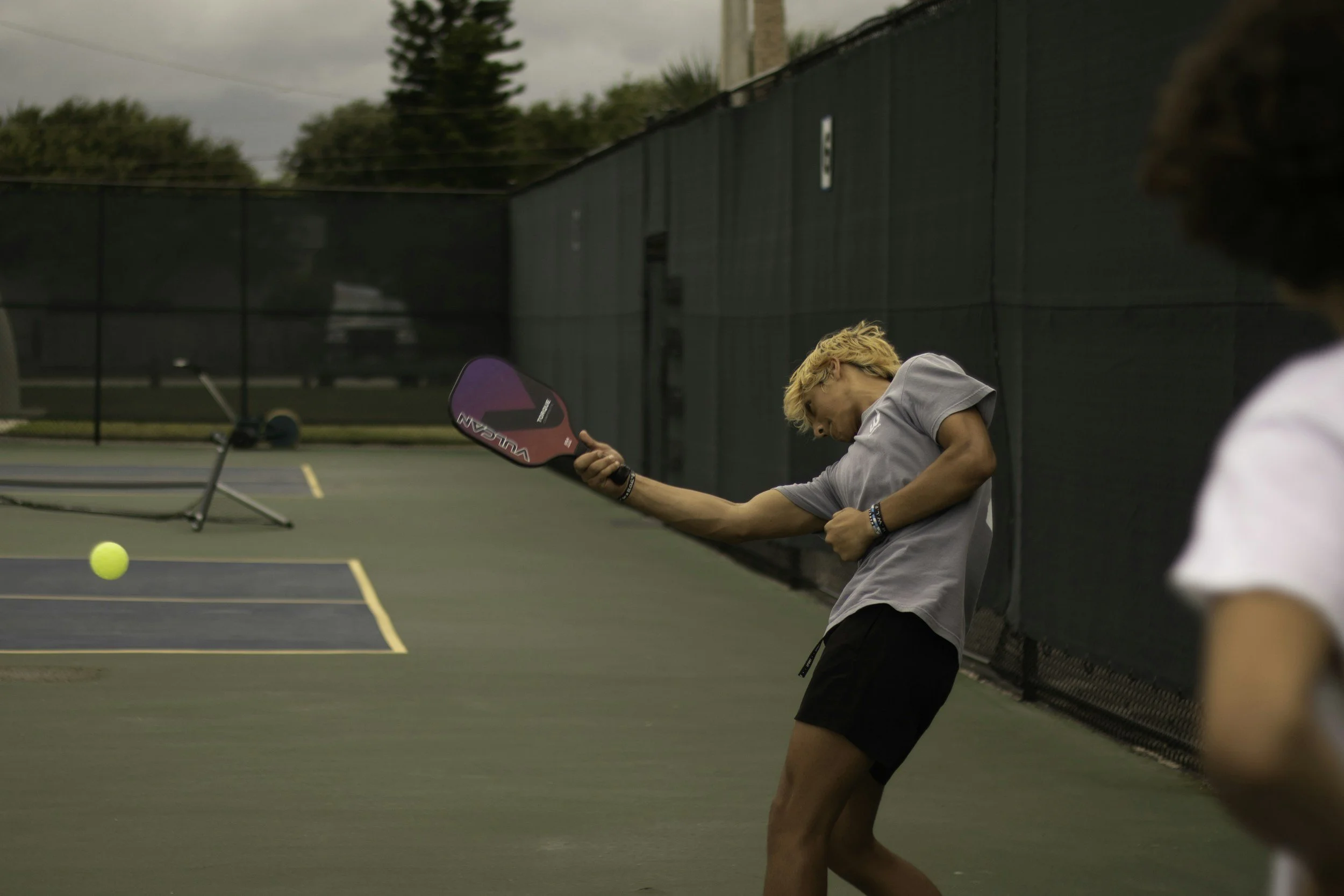 Teenager playing pickleball.