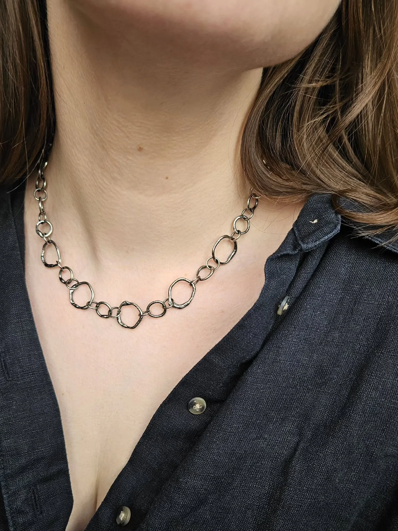 Interlinked. This striking necklace has been handcrafted, working with recycled sterling silver and traditional tools.

Link by link, each element is carefully hand fabricated before being finished with a bold patina to accentuate the organic shapes.