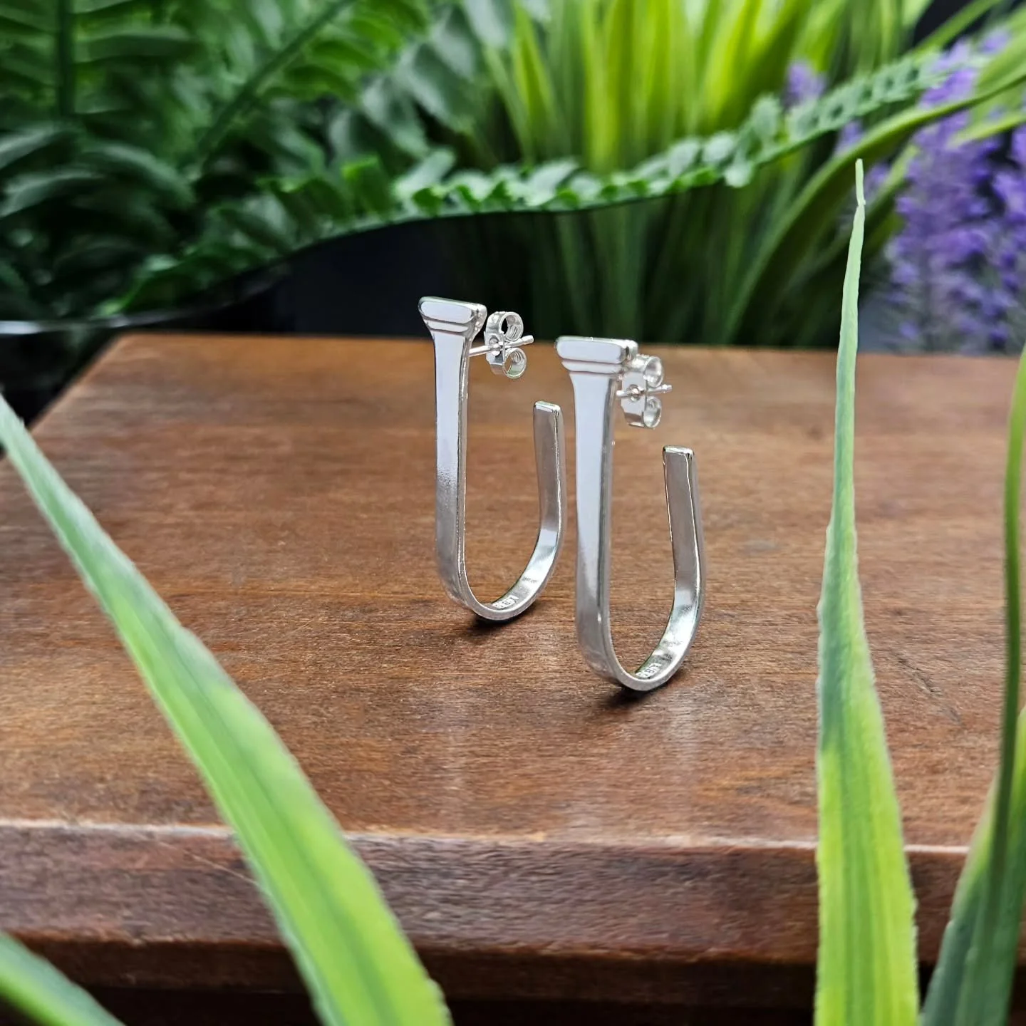 Low Rider Hoop Earrings.

These unique drop style silver hoop earrings have been handcrafted in my studio using sustainable sterling silver. Crafted using recycled silver spoon handles, the original hallmark can be found on the inside of each hoop.

