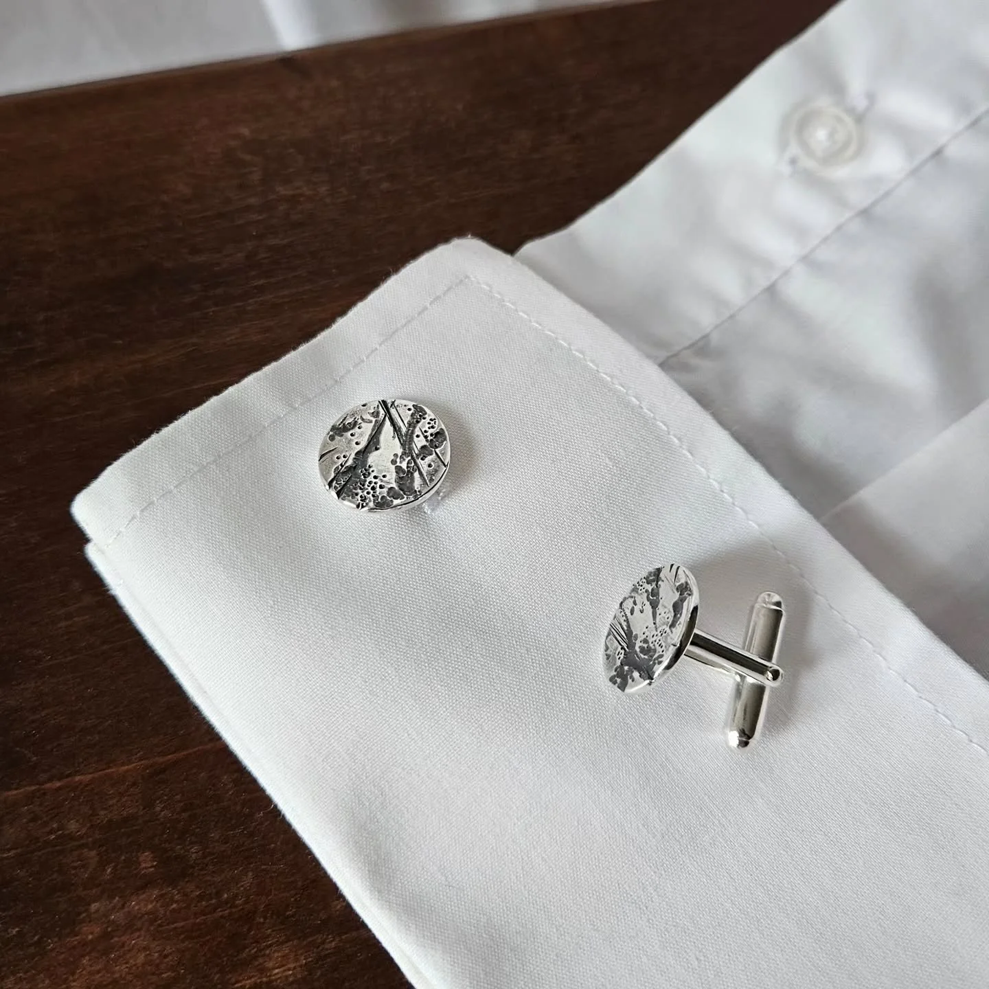 Relic Cufflinks - sterling silver with a weathered texture finish.

These blackened silver cufflinks have been handcrafted in my Northern Ireland studio using traditional jewellery making techniques. 

Each pair is created from recycled sterling silv