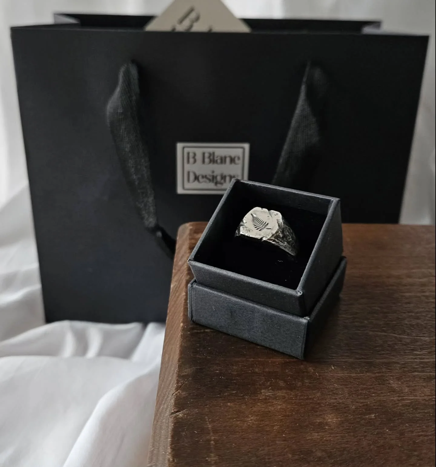 I had so much fun working on this bespoke signet ring recently. We chose to add a fern leaf to the face of the ring because nature and plants are a big part of life for this individual. 

Finished with a weathered texture and given a blackened patina