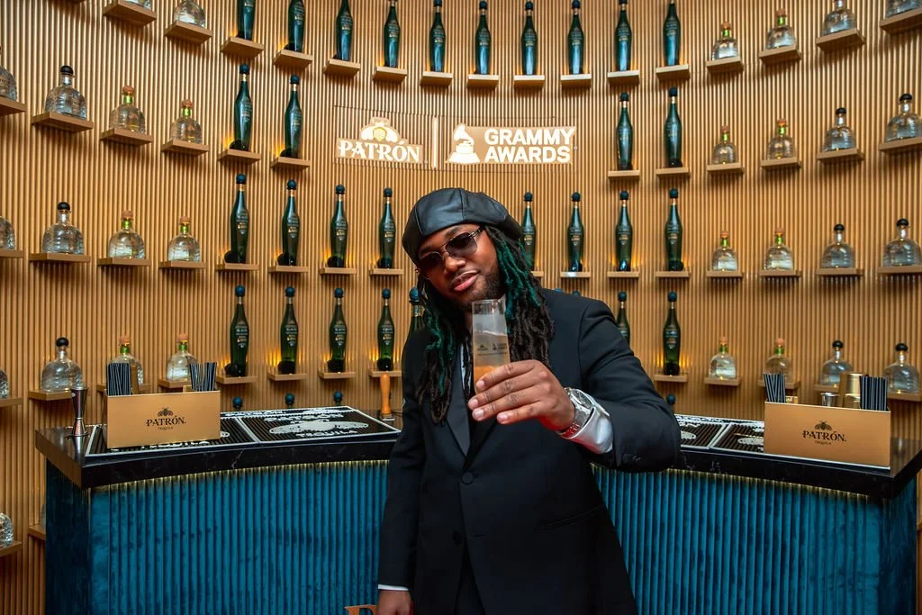 Leon Thomas celebrating his Grammy Award win at the Patrón Tequial Media Center Bar