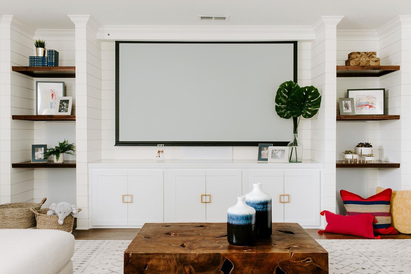 Transformation Tuesday, on a Wednesday! Transforming a movie and playroom!  We installed shiplap on the back wall and constructed a built in with floating wood shelves flanking the TV. Hidden behind the floating shelves we have concealed two surround