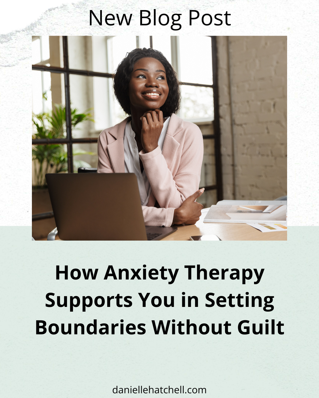 Woman in a pink jacket smiling confidently while sitting at her laptop. Danielle Hatchell LCPC offers Anxiety Therapy Maryland for High Achieving Professionals