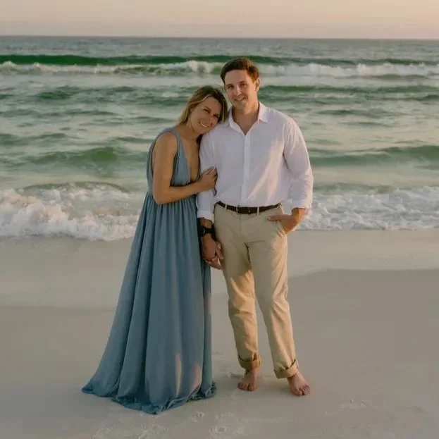 Couple embracing on the beach at golden hour