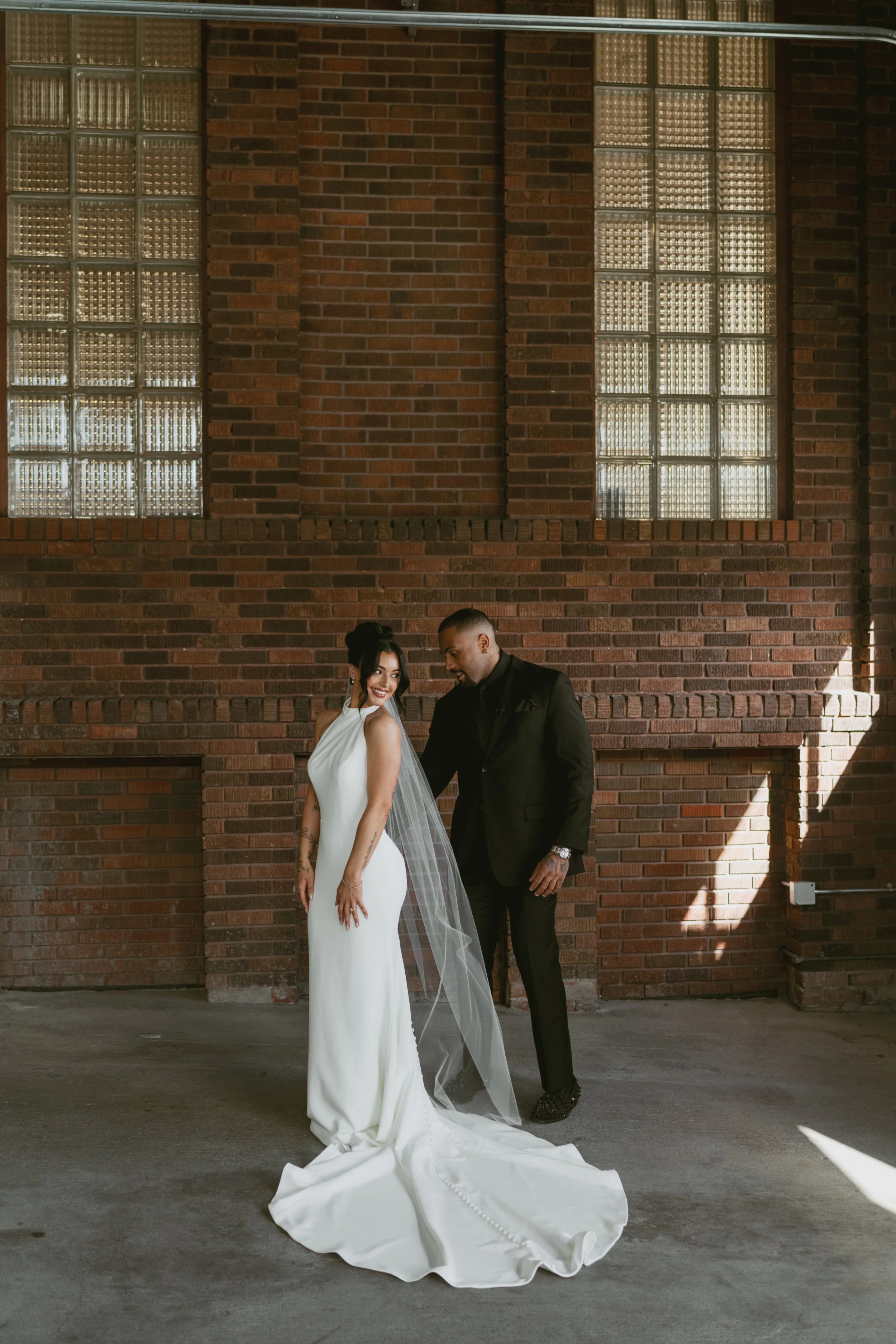  Bride and groom during first look on wedding day, groom looking at bride for the first time admiring how beautiful she looks 