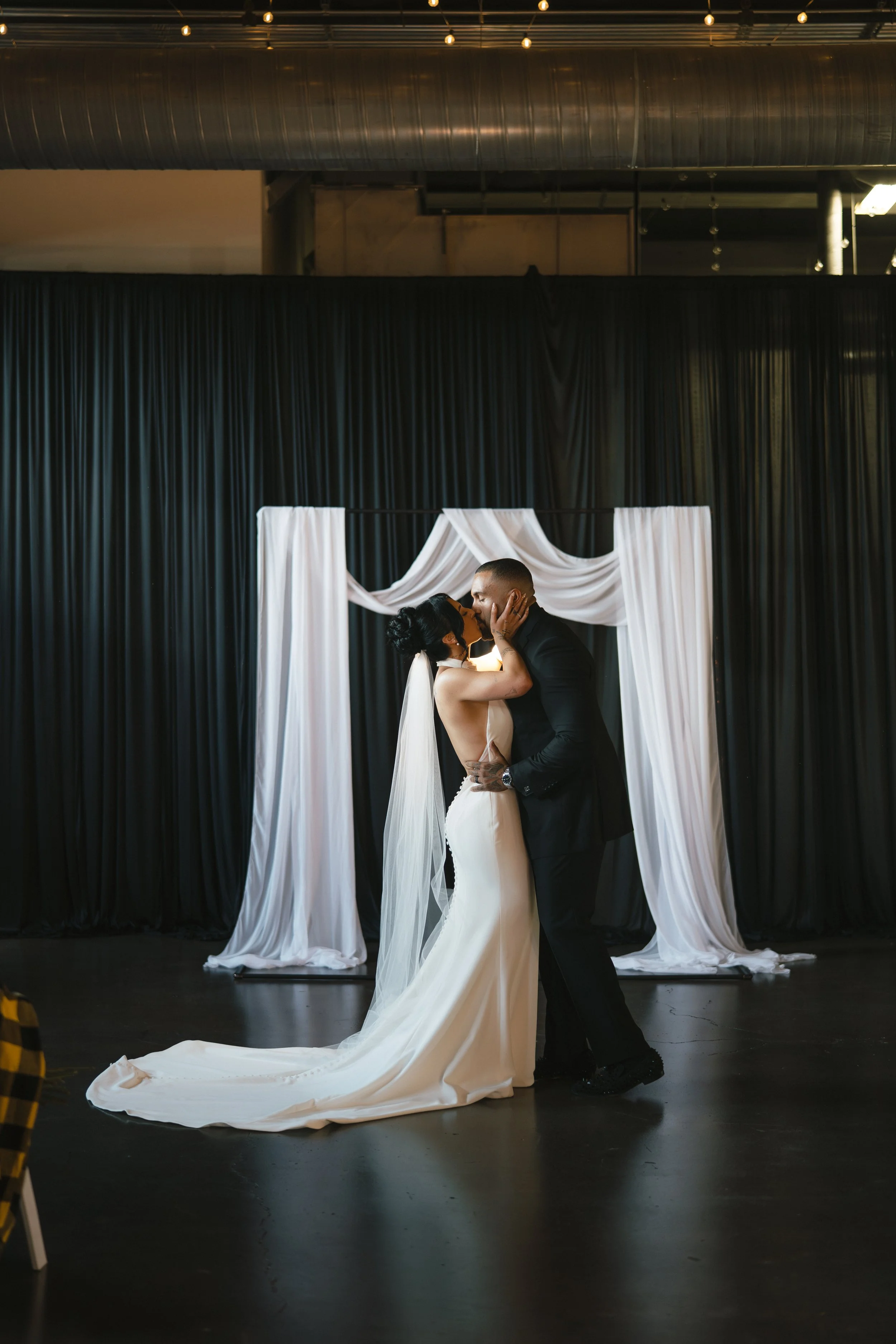  bride and groom kiss during ceremony  