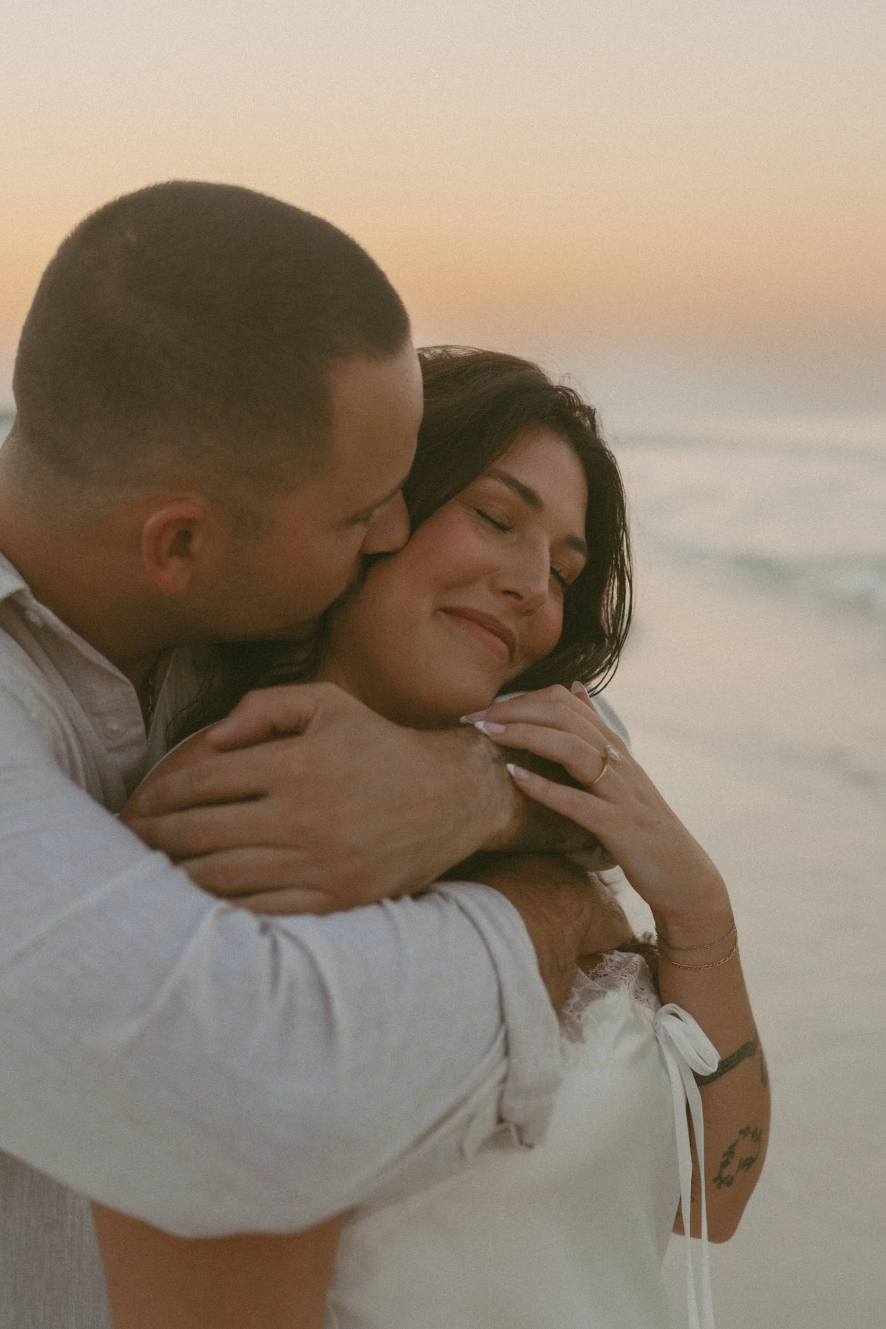 Man and woman embracing in a hug at sunset golden hour