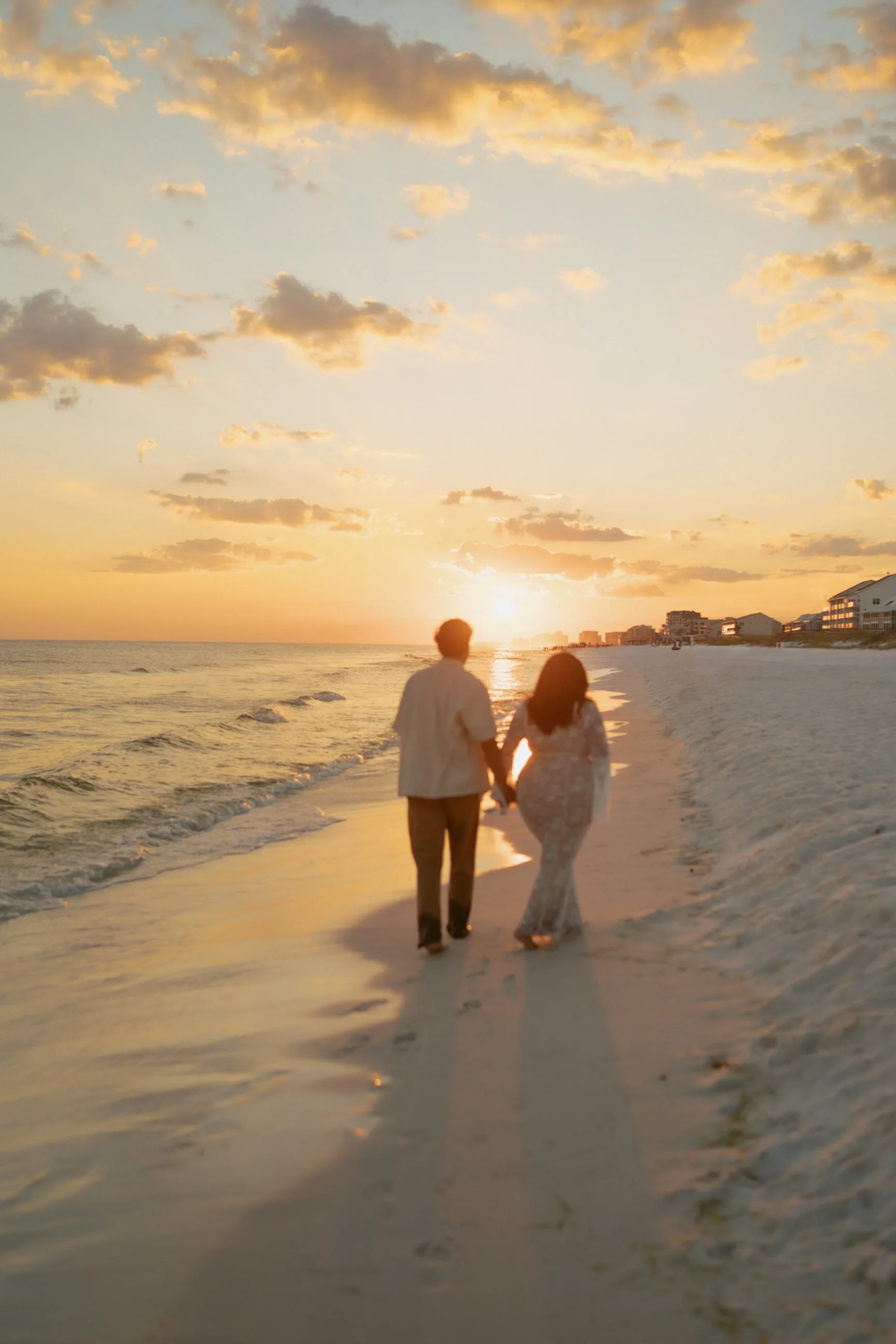 Couple walking on Florida 30A beaches at sunset and golden hour
