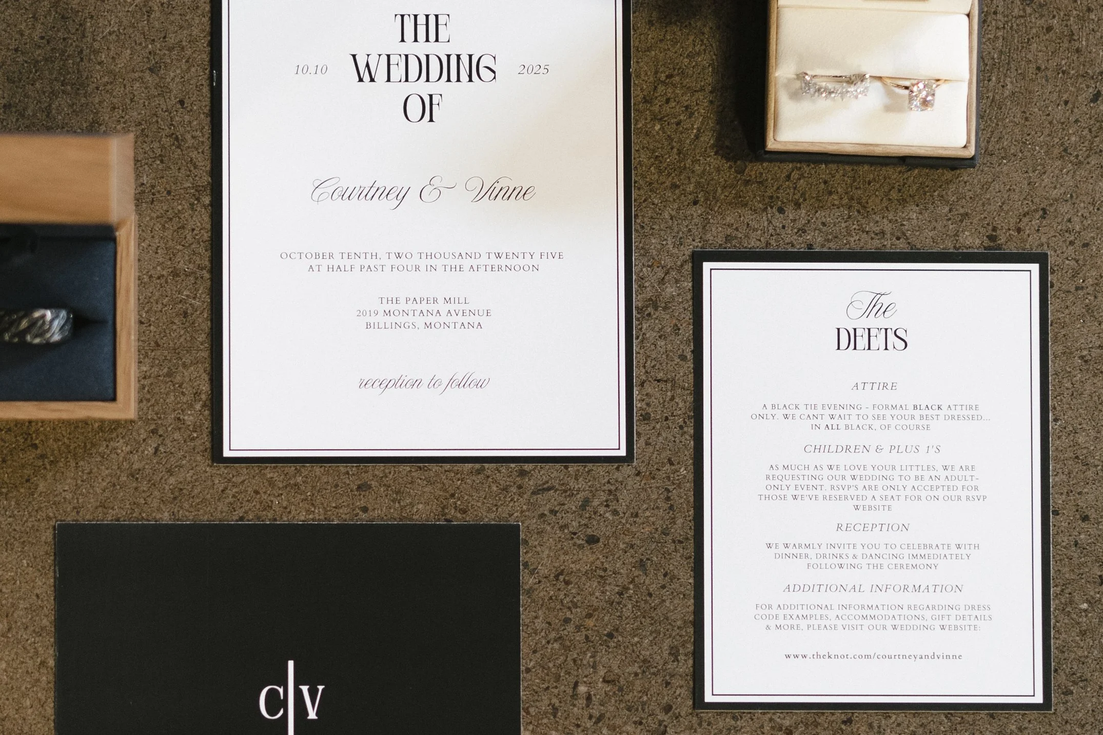  flatlay of wedding day details including the invitation suite, watch, rings, and ceremony newspaper  