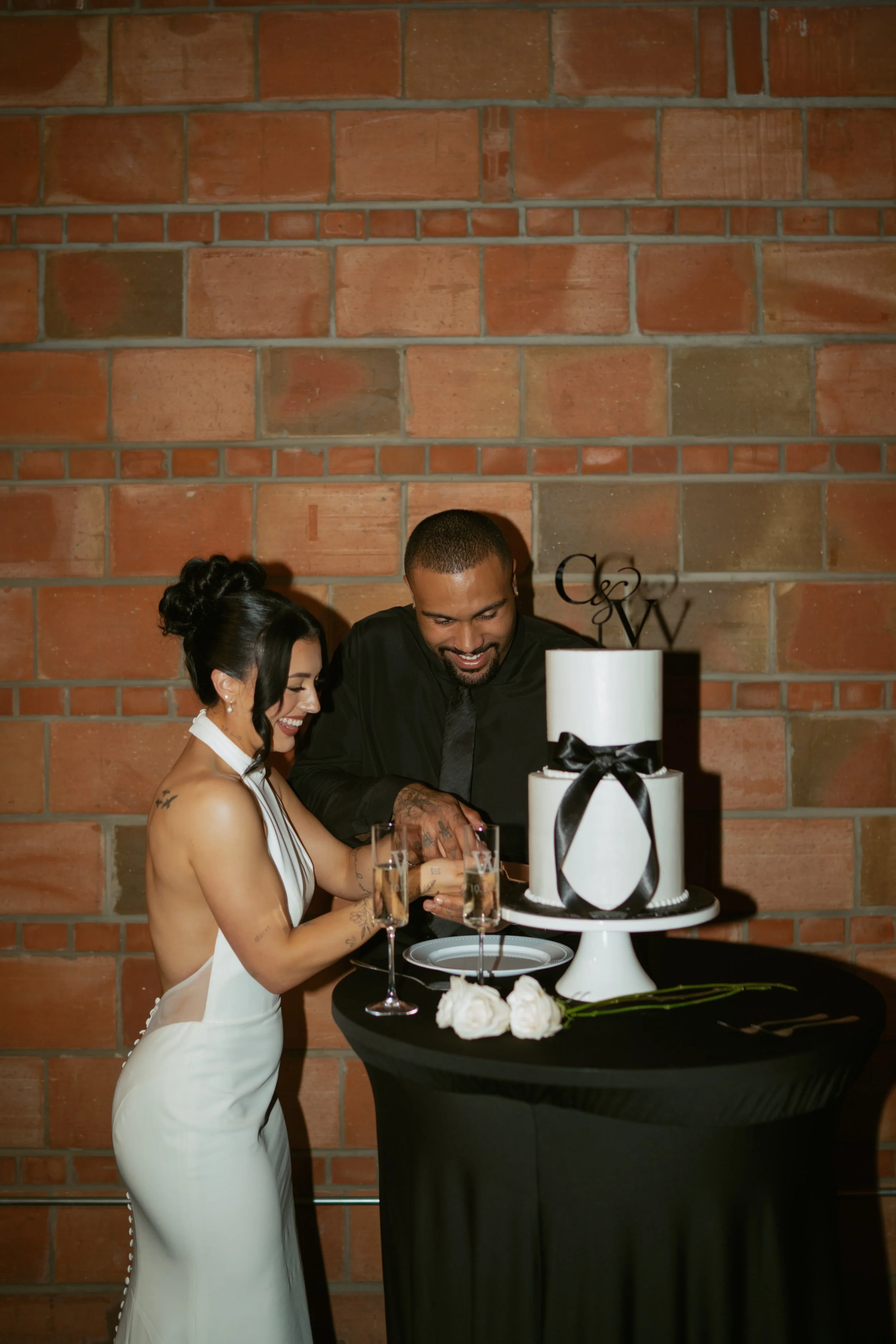  bride and groom cutting their wedding cake  
