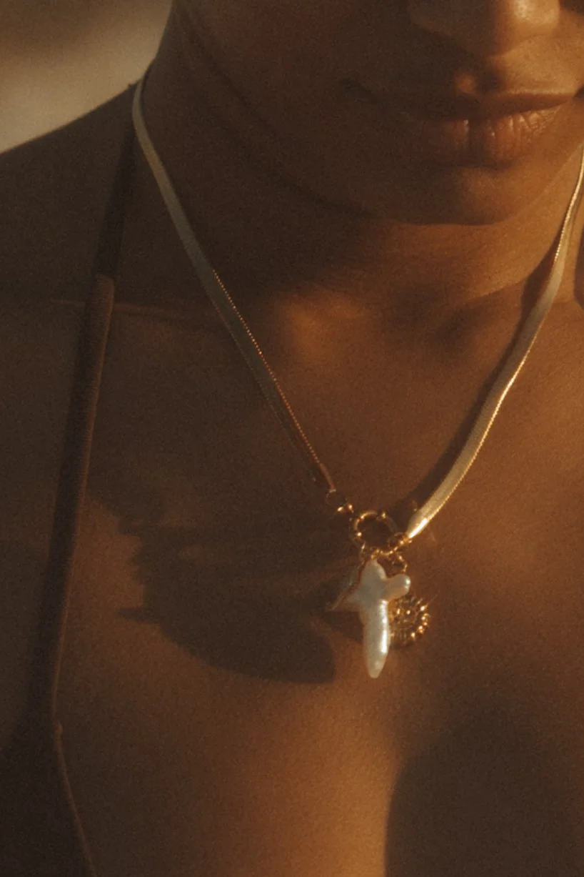 photo of model wearing charm necklace on the beach in Destin, FL