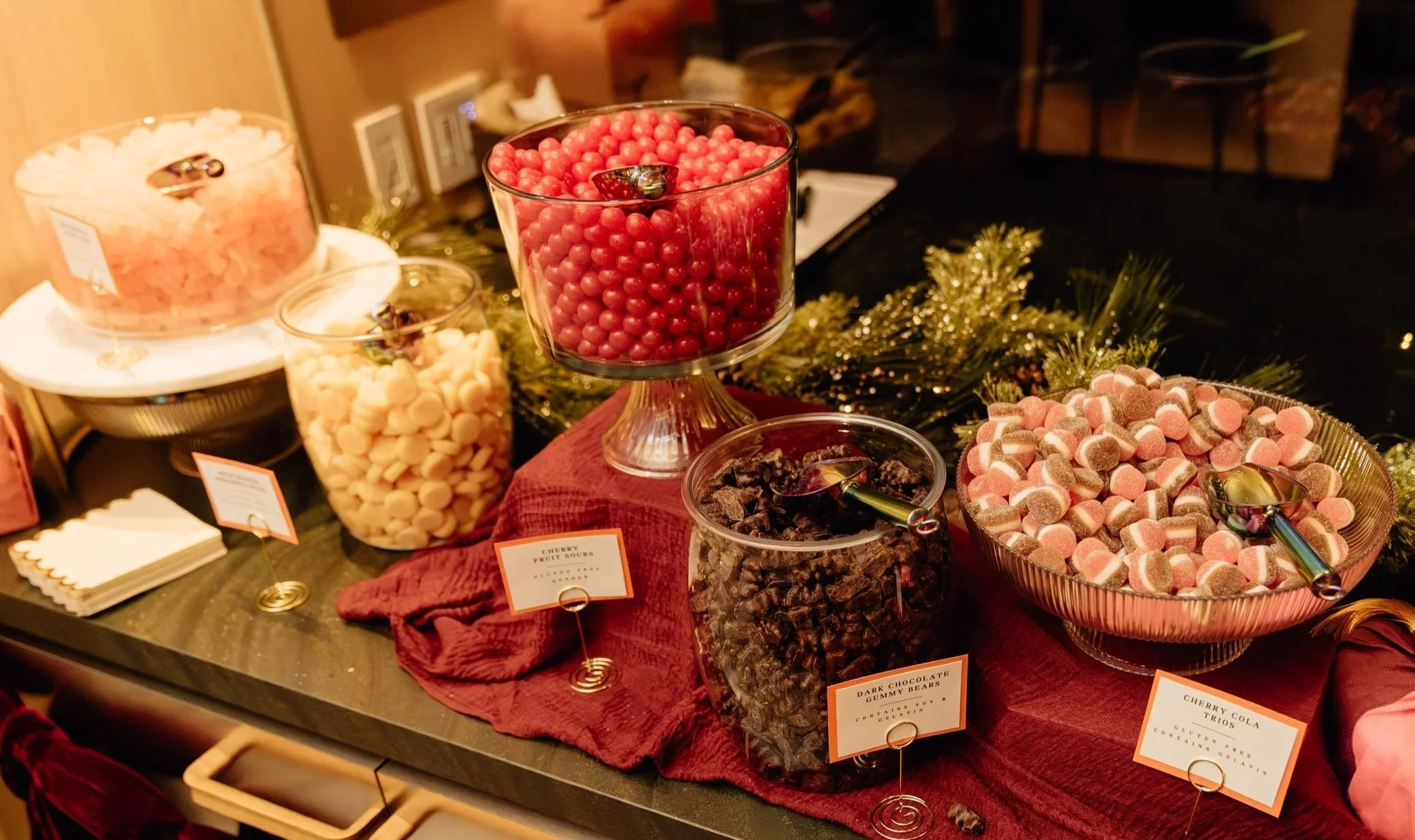 5 colorful plates of candy sitting on a light green background