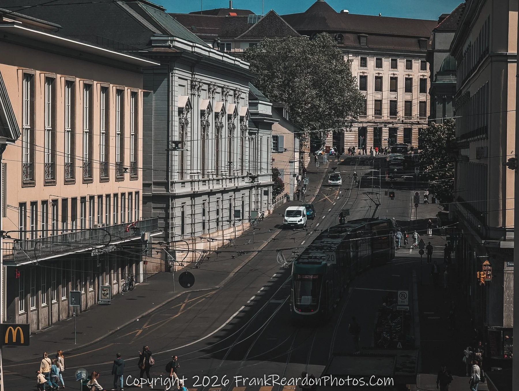 “City in Motion” Basel’s streets pulse with movement, framed by timeless façades and intersecting lives.