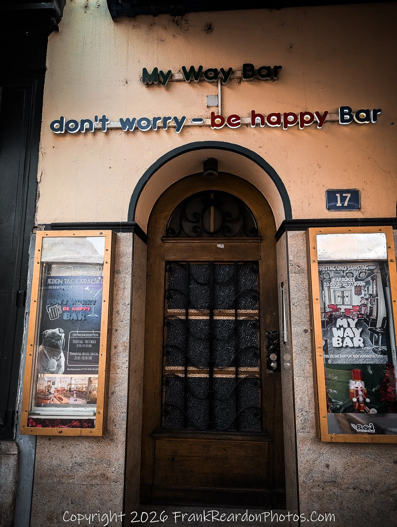 “Don’t Worry, Be Happy” A doorway of color and charm, echoing the city’s playful spirit and nocturnal hum.